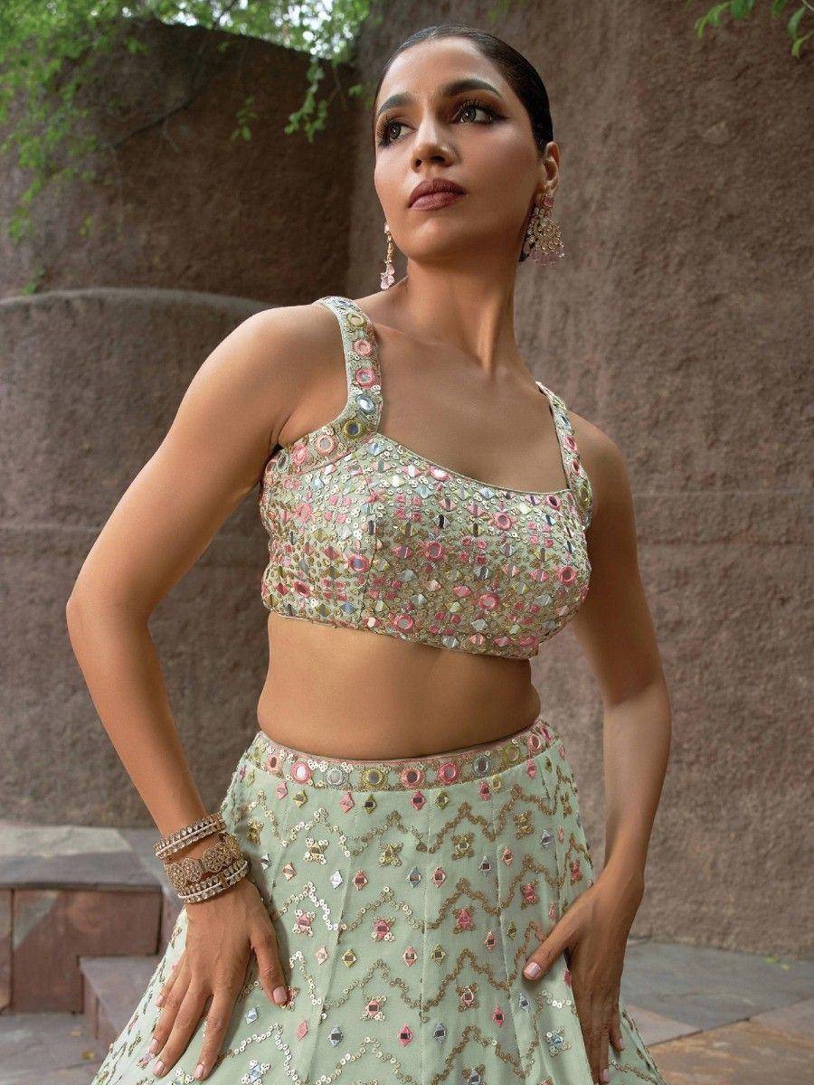 Designer lehenga choli with mirror work, pastel green skirt and floral embellished blouse for Indian ethnic wear