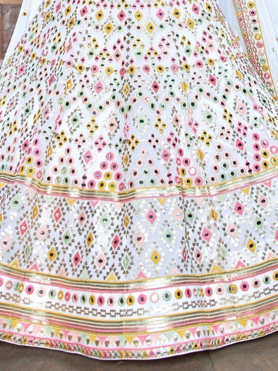 White lehenga with colorful mirror work and geometric embroidery, ethnic Indian wear