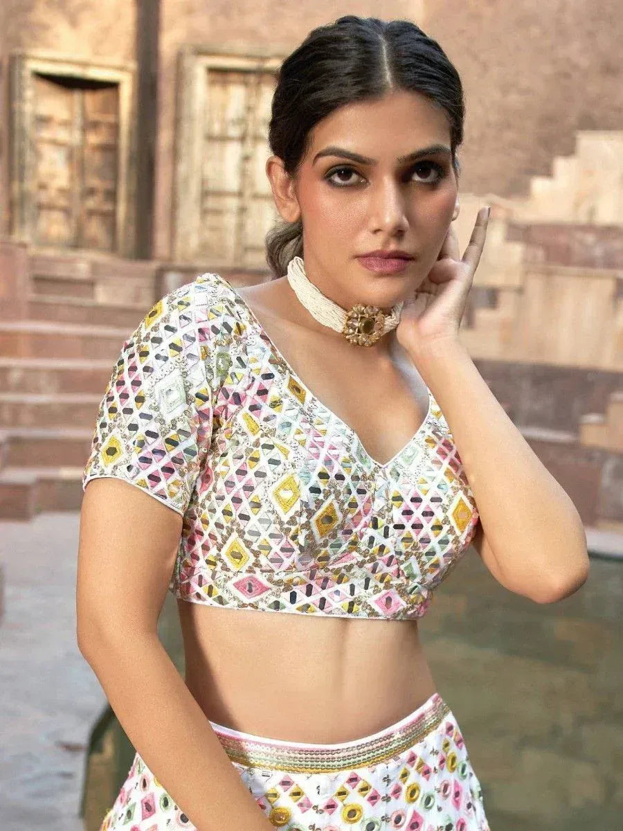 Woman in colorful geometric print lehenga choli with choker, traditional Indian ethnic wear