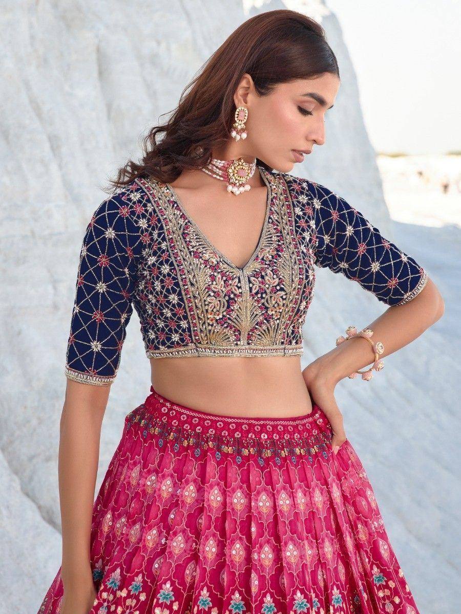 Elegant Indian lehenga choli with navy blue embroidered blouse and pink floral skirt, perfect for weddings and festivals.