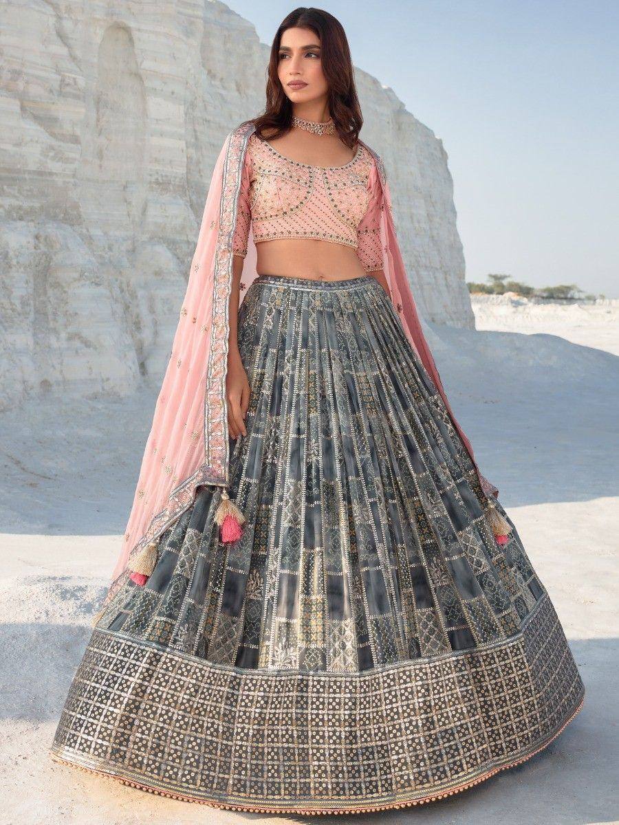 Elegant Indian lehenga choli with pink blouse, embroidered grey skirt, and dupatta, perfect for weddings or festivals.