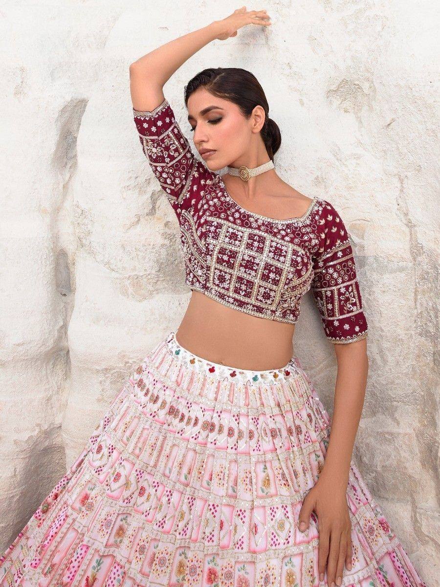 Maroon and pink embroidered lehenga choli with detailed mirror work, perfect for Indian ethnic wear occasions.