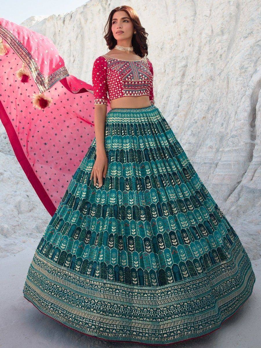 Teal printed lehenga with red blouse and pink dupatta, ethnic Indian wear for weddings or festivals