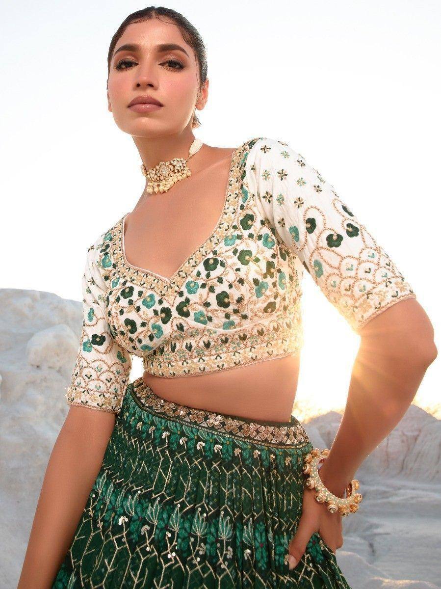 Green and white embroidered lehenga choli with floral motifs, perfect for Indian ethnic wear occasions