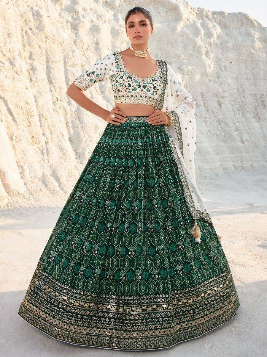 Emerald green designer lehenga choli with intricate embroidery, perfect for Indian weddings and festive occasions.