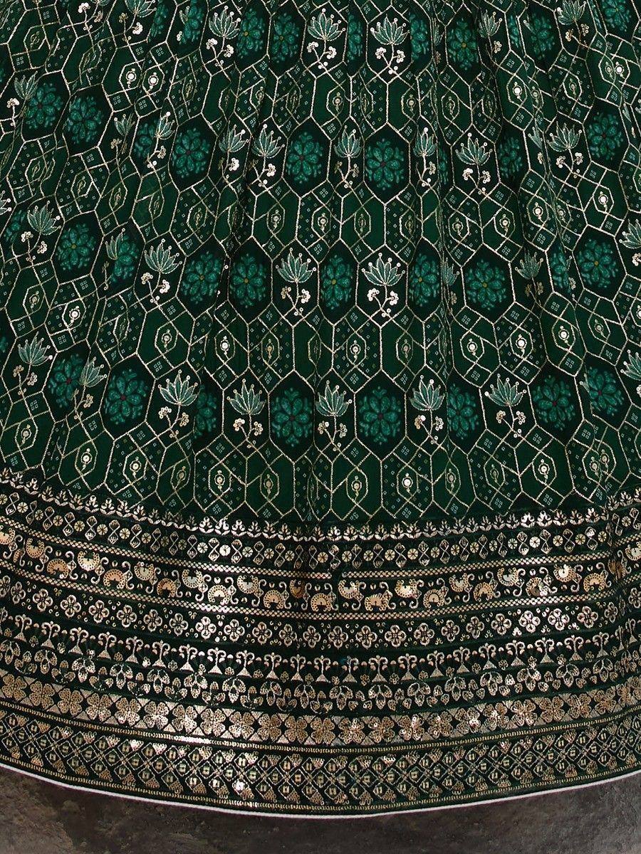 Emerald green lehenga with intricate gold floral embroidery and detailed border design