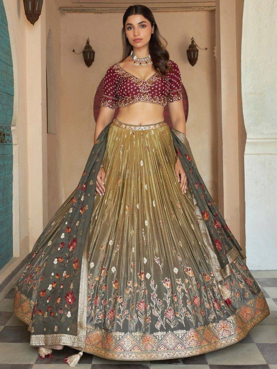 Elegant maroon and gold embroidered lehenga choli with floral dupatta, perfect for Indian ethnic occasions.