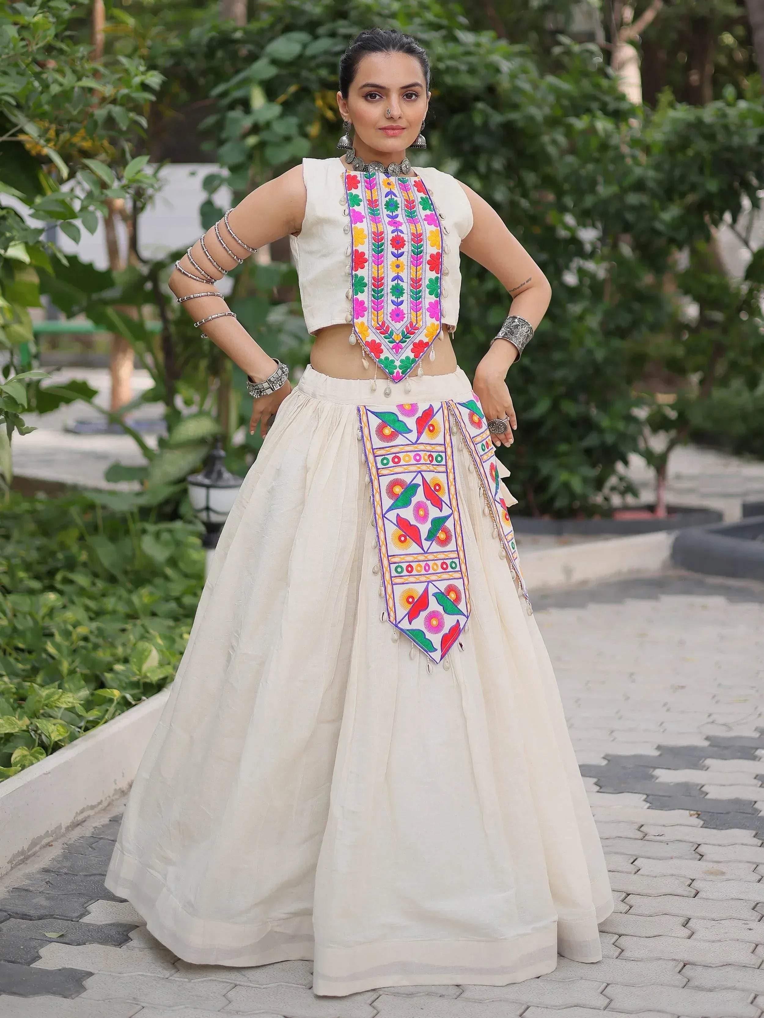 White embroidered lehenga choli with colorful floral patterns, perfect for Indian ethnic wear