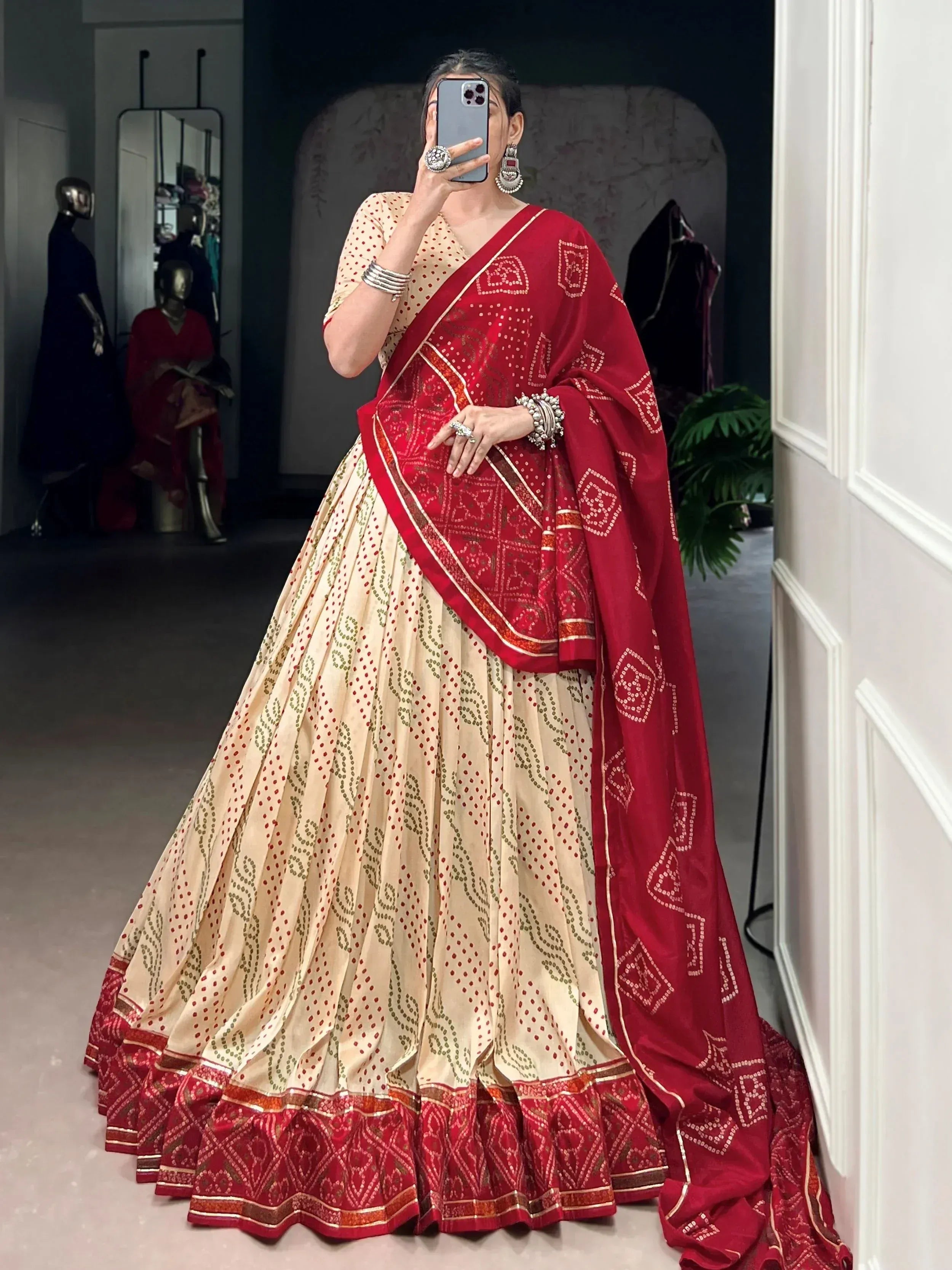 Red and cream designer lehenga choli with intricate patterns and ethnic embroidery