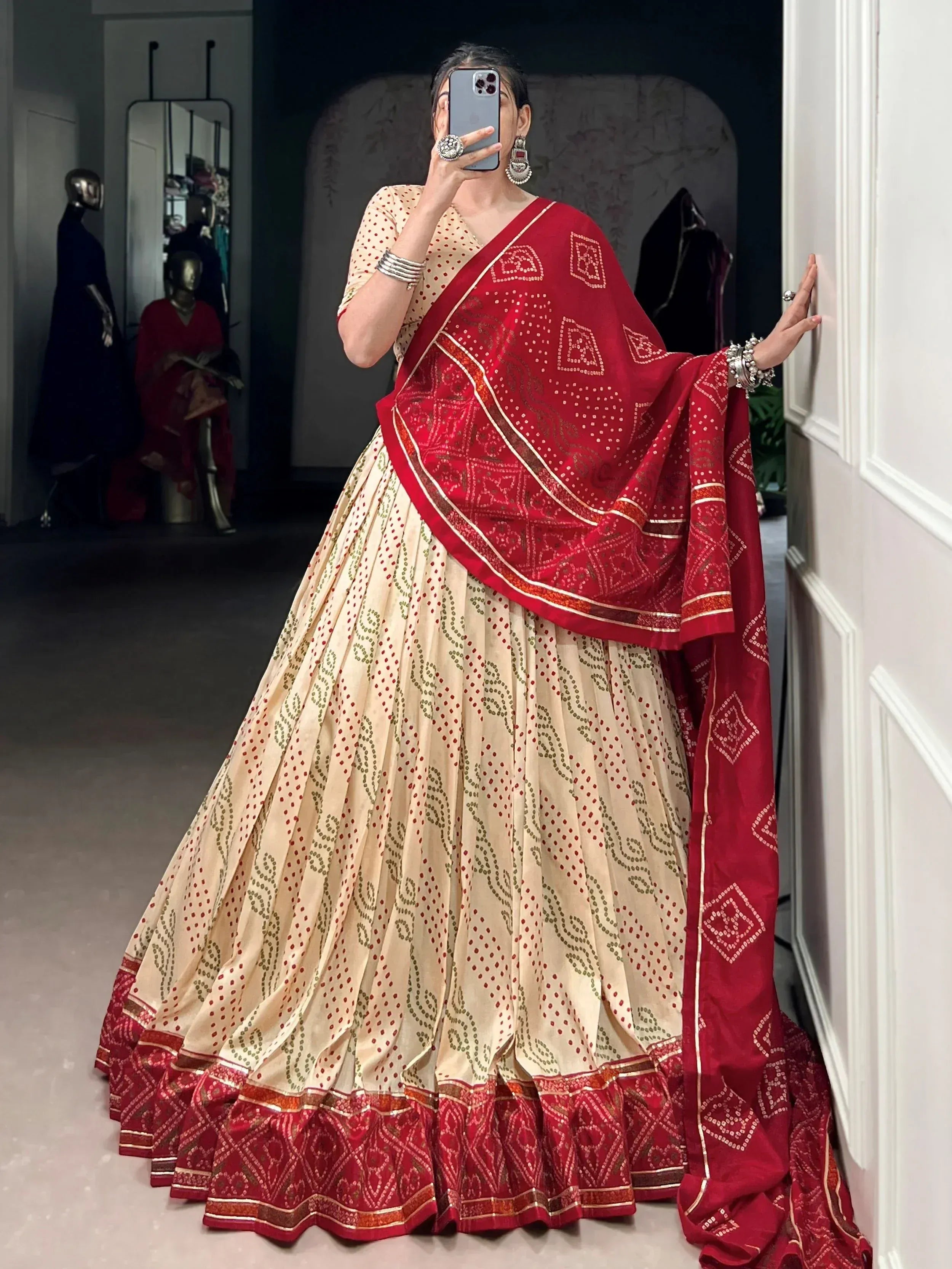 Elegant cream and red lehenga choli with intricate embroidery and matching dupatta for Indian ethnic wear