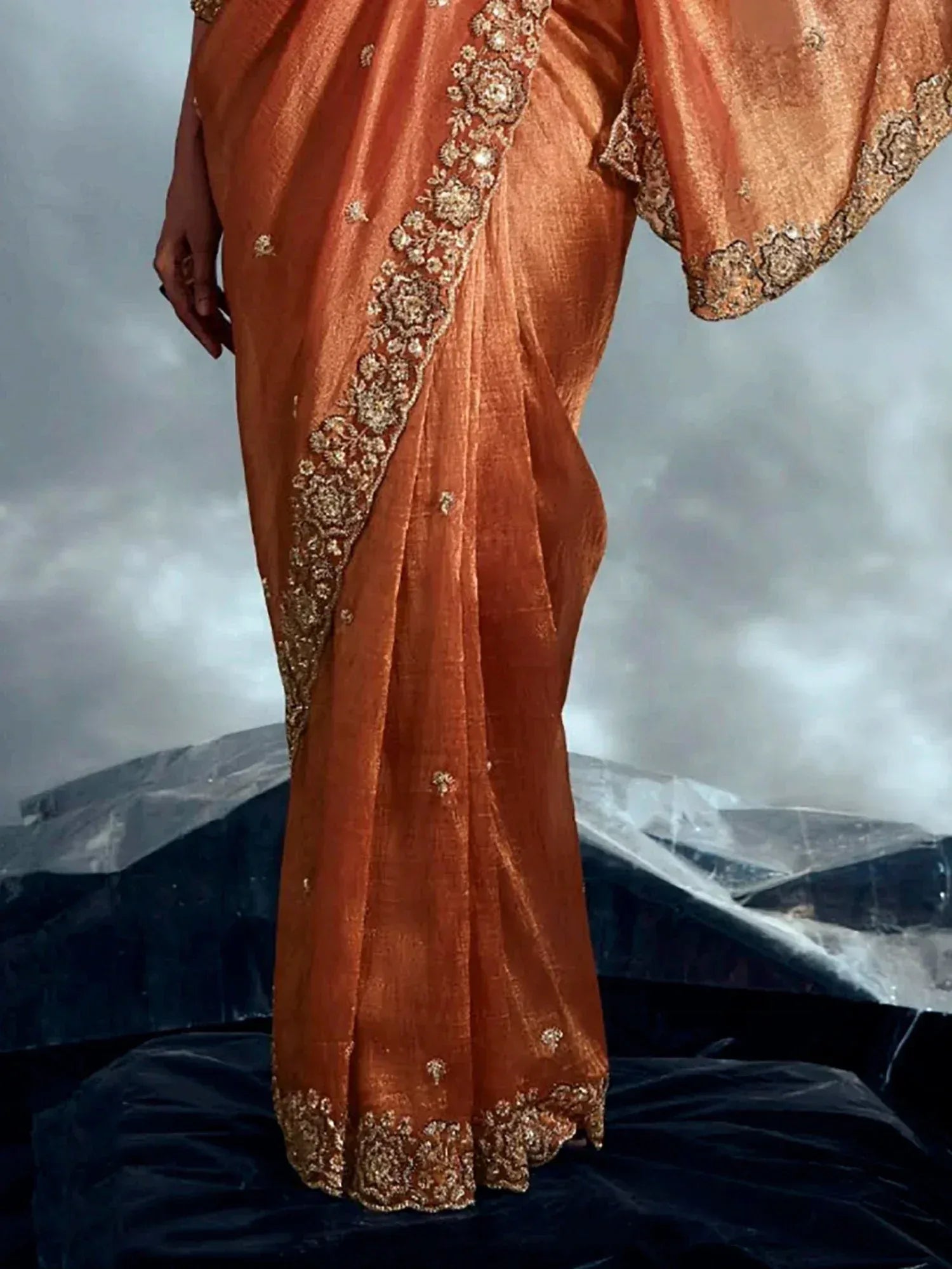 Orange silk saree with gold floral embroidery, perfect for Indian ethnic wear and festive occasions