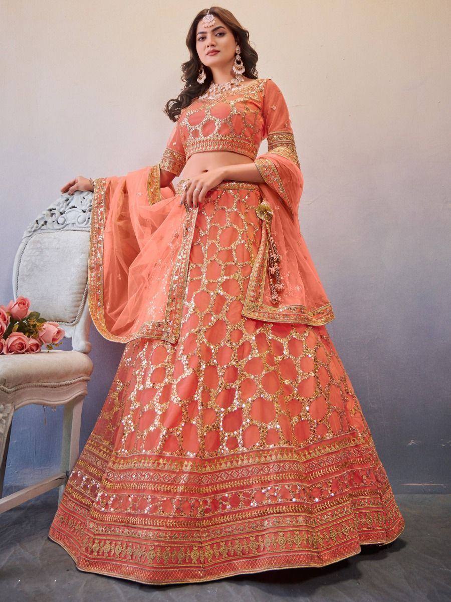 Peach designer lehenga choli with gold embroidery and sequin work, perfect for Indian weddings and festive occasions.