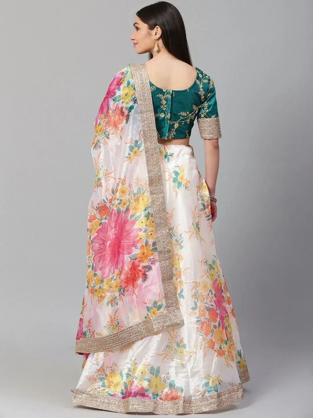 Floral print lehenga choli with green embroidered blouse and gold trim, perfect for Indian ethnic occasions.