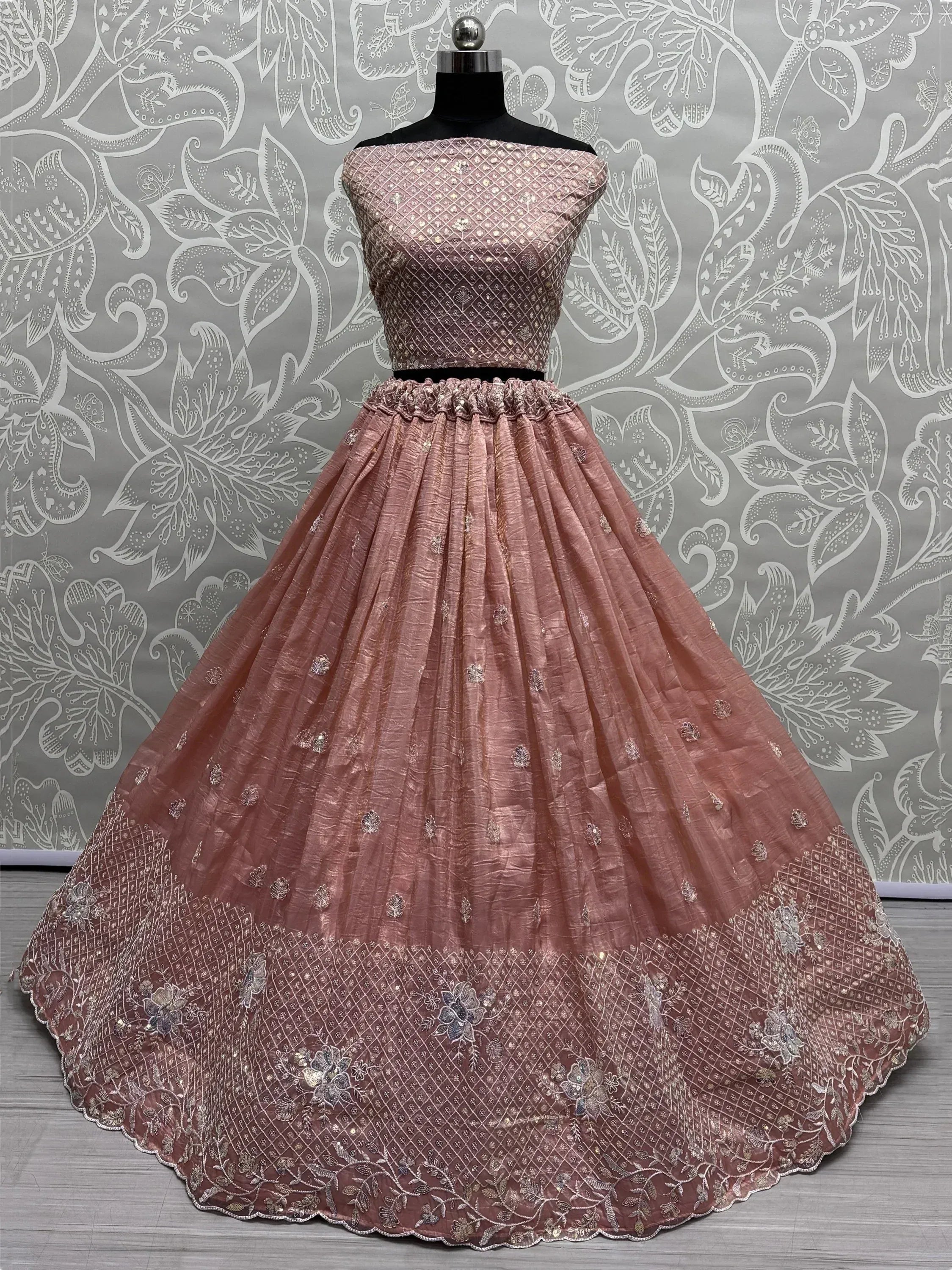 Dusty pink designer lehenga choli with intricate embroidery and sequin work, perfect for Indian ethnic wear.