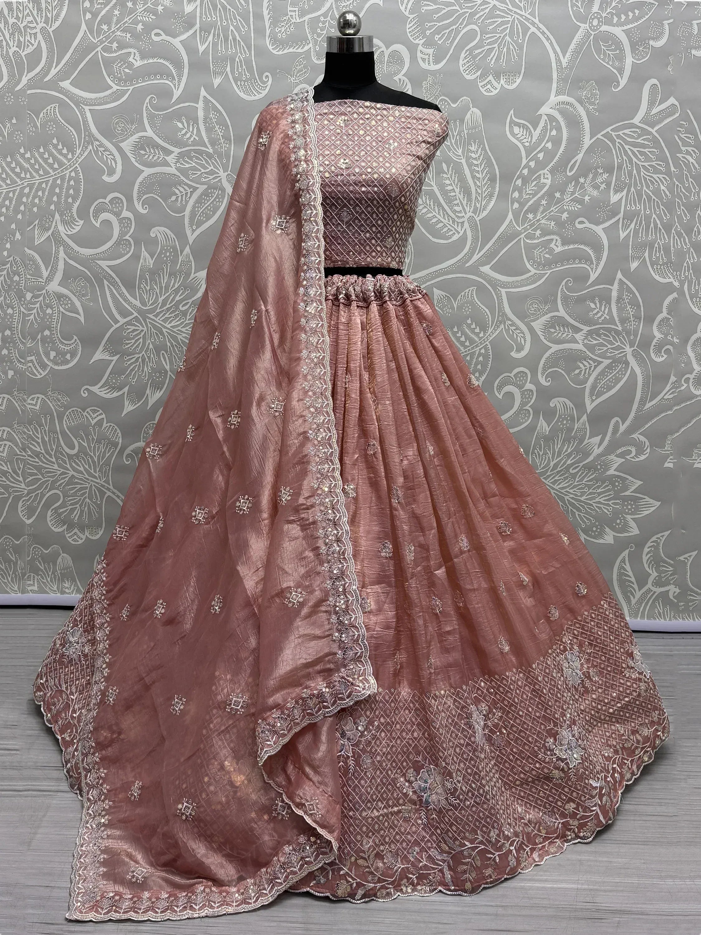Dusty rose designer lehenga choli with intricate embroidery and lace detailing, perfect for Indian ethnic wear occasions.