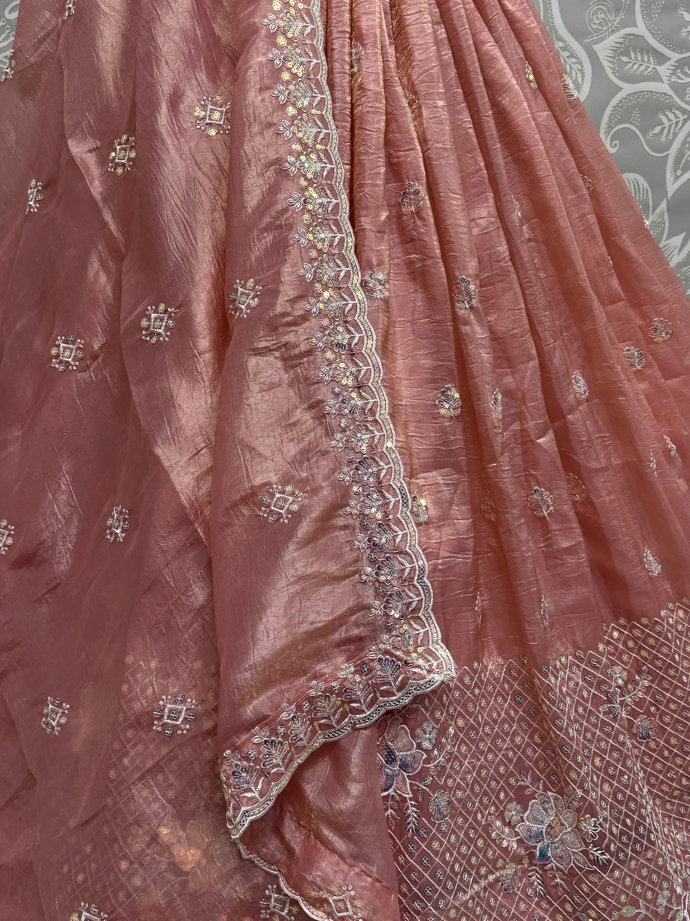 Dusty rose ethnic lehenga with floral embroidery and sequin detailing, perfect for Indian weddings and festive occasions.