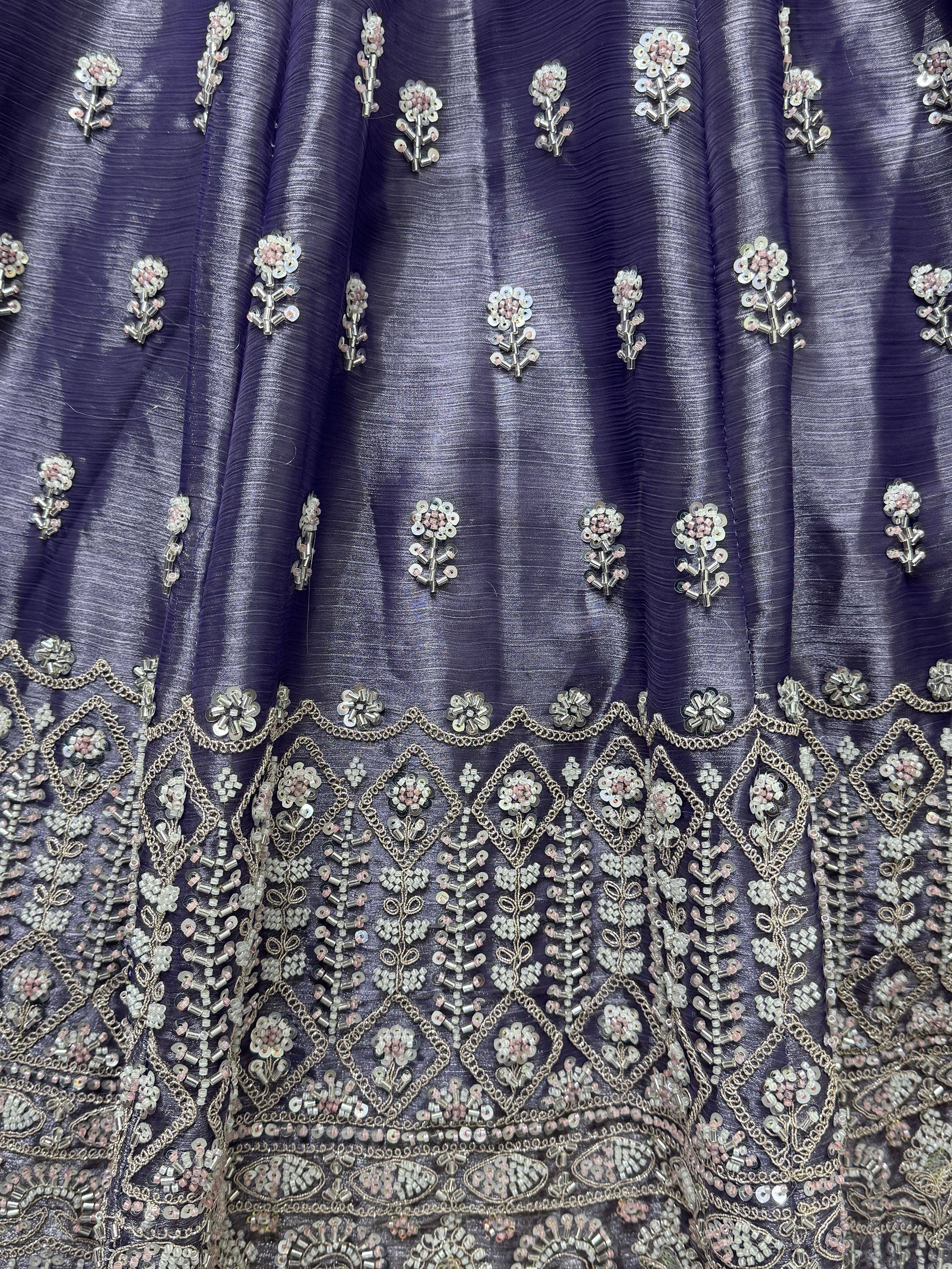 Purple ethnic gown with floral sequin and bead embroidery, perfect for Indian weddings or festive occasions.