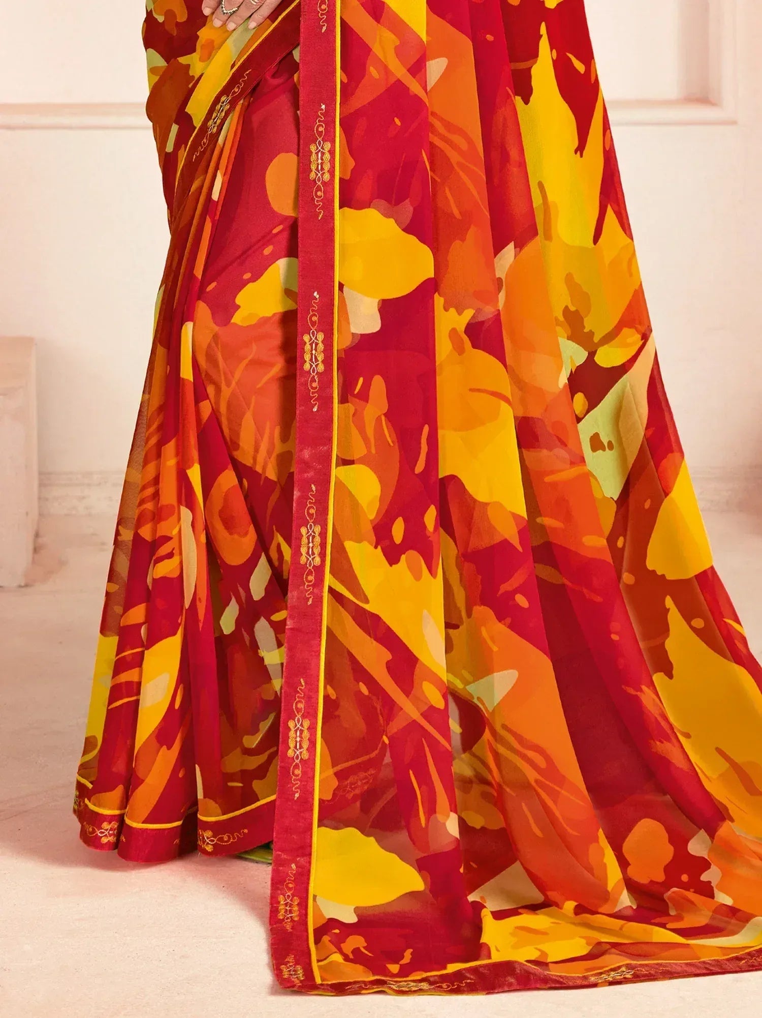 Vibrant red and yellow printed saree with gold border, ethnic Indian wear for women