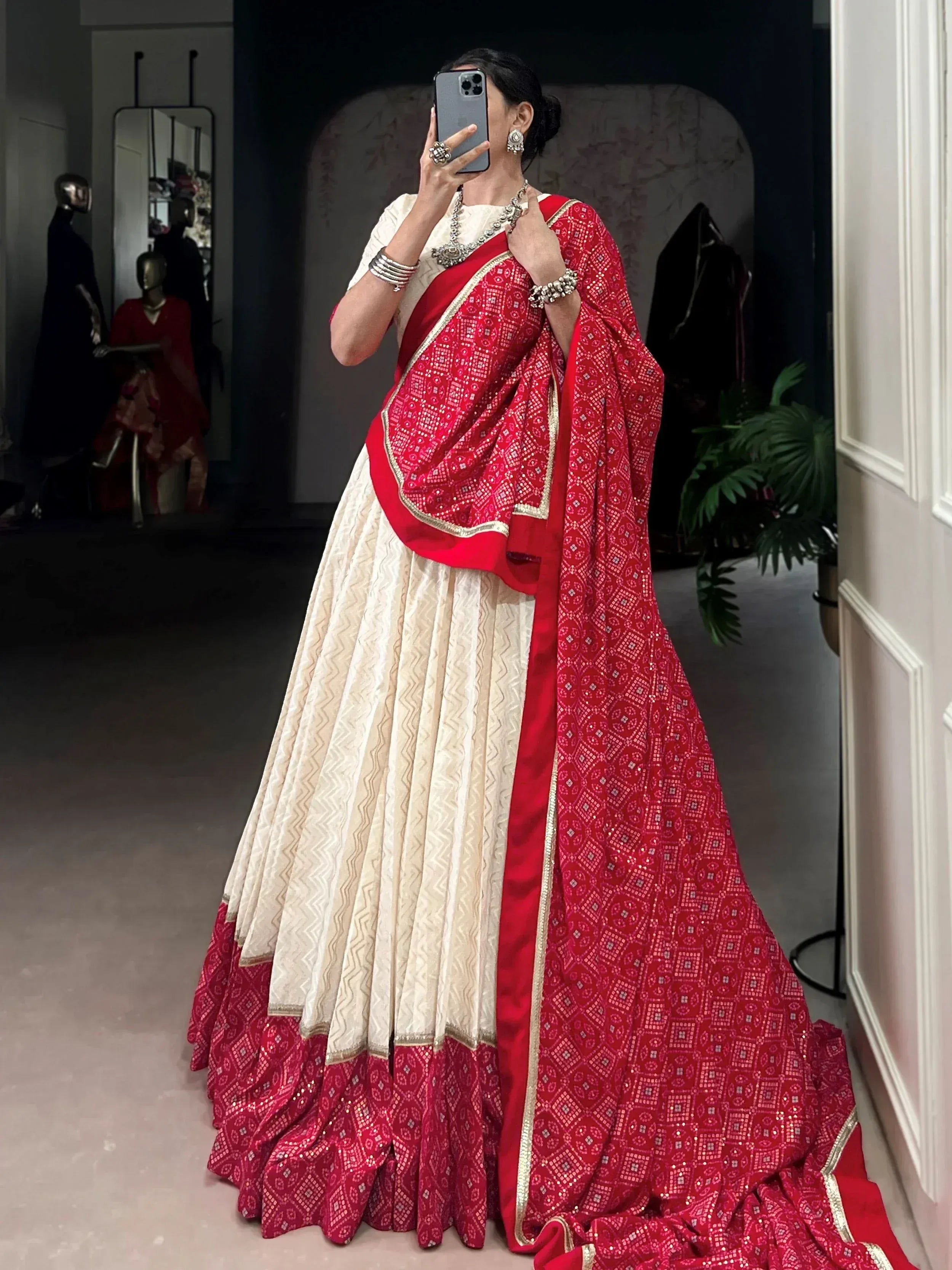 Red and cream designer lehenga choli with intricate embroidery and gold trim, perfect for Indian ethnic wear