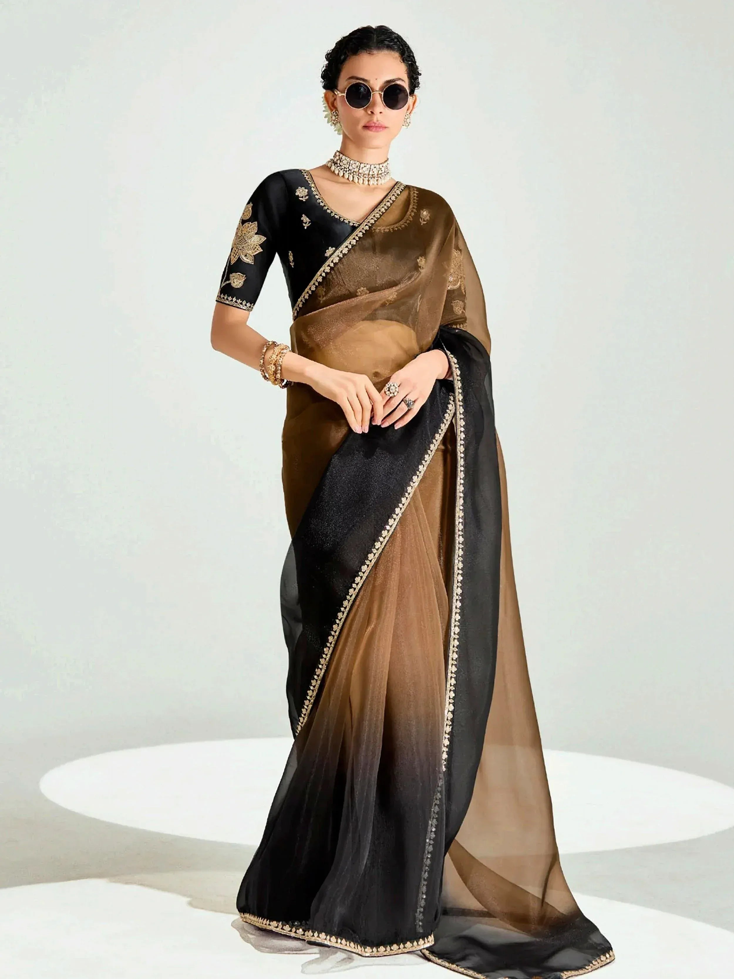Elegant black and brown saree with gold embroidery, perfect for Indian ethnic wear occasions.