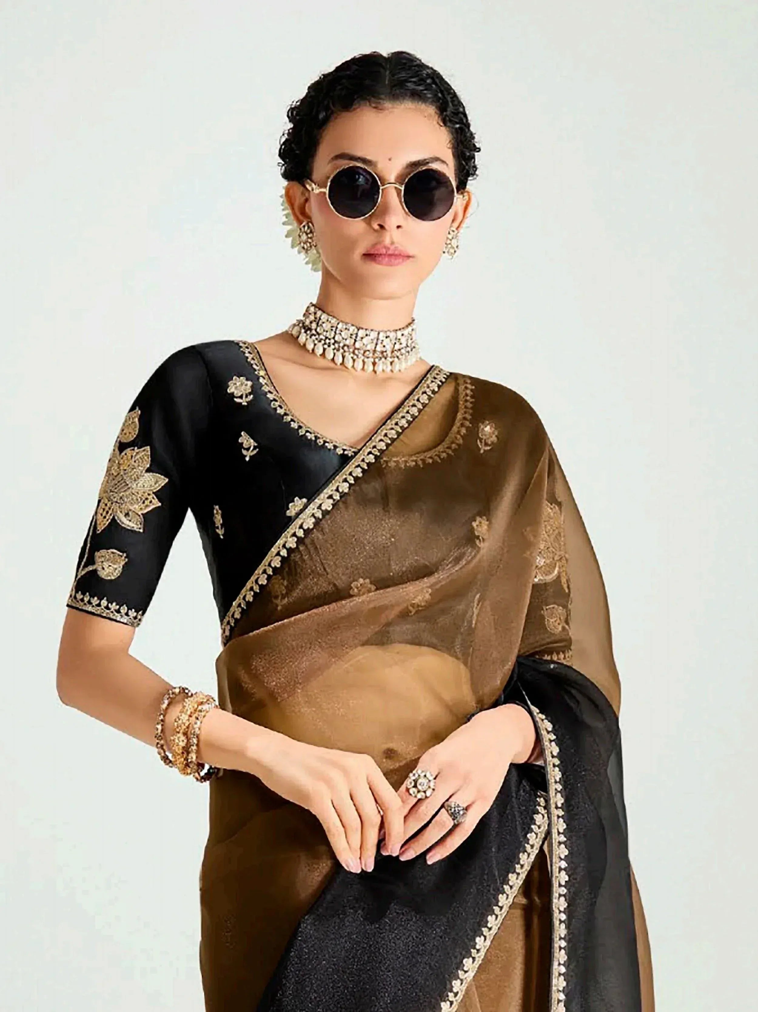 Elegant black and gold embroidered saree with designer blouse, perfect for Indian ethnic wear occasions