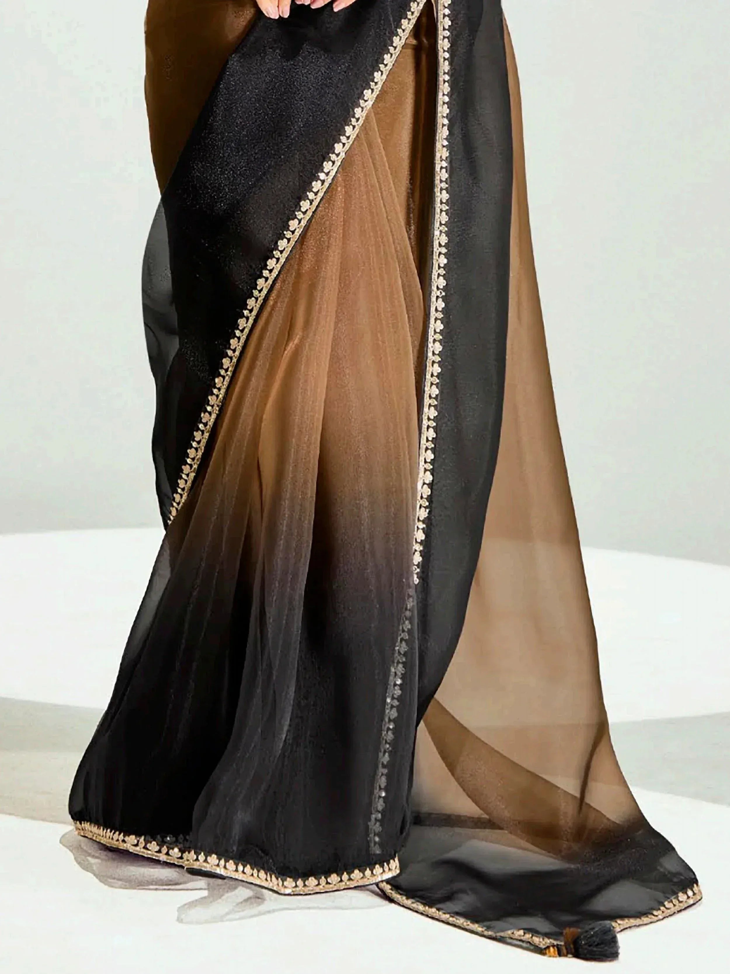 Black and brown ethnic saree with gold border detailing, perfect for Indian festive wear