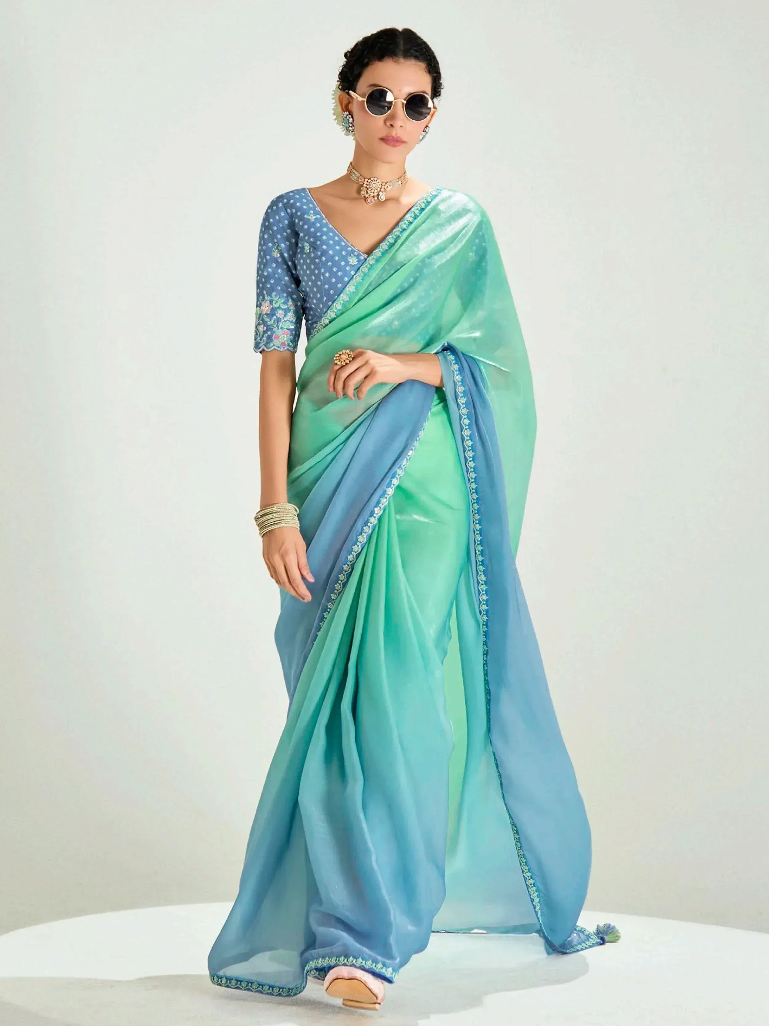 Woman in mint green and blue ombre saree with embroidered blouse, perfect for Indian ethnic wear occasions