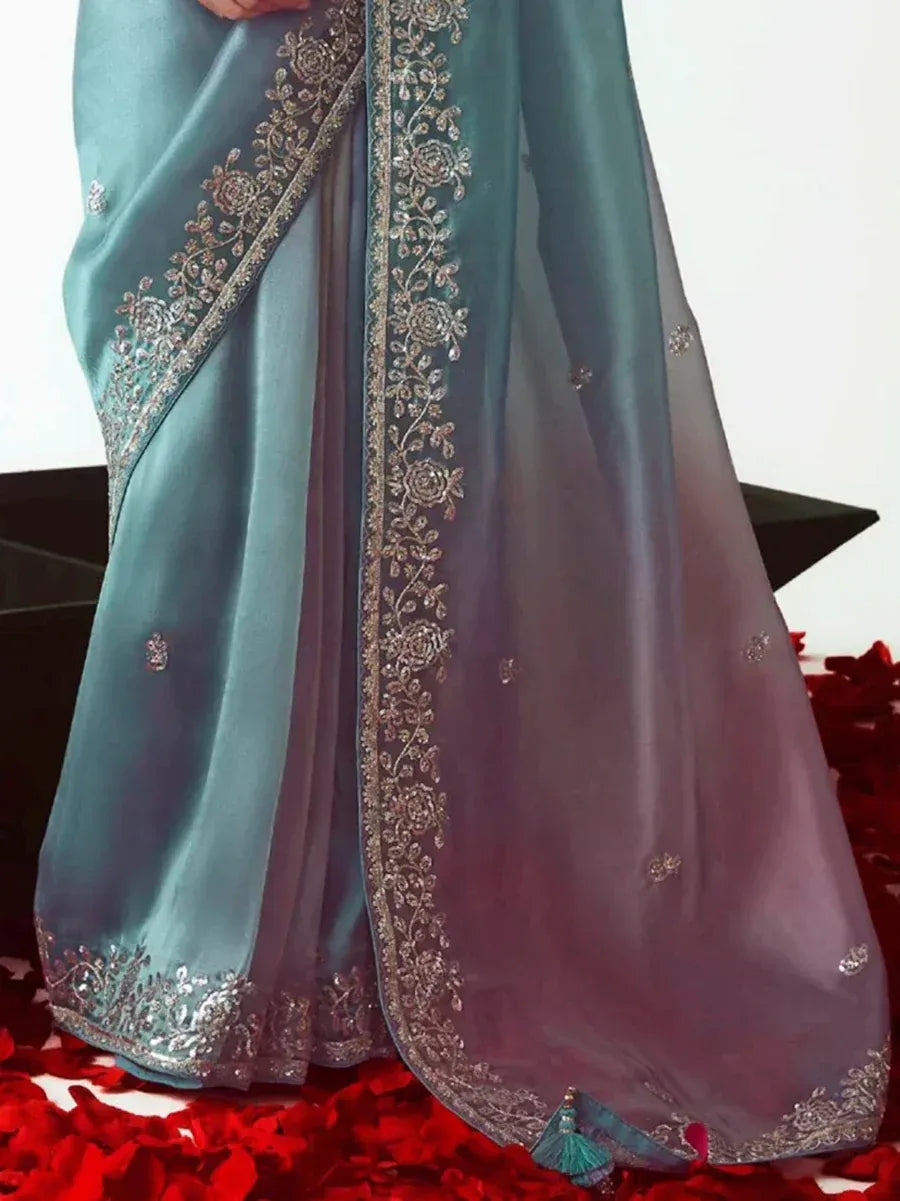 Teal and mauve designer saree with floral embroidery and tassels, perfect for ethnic occasions