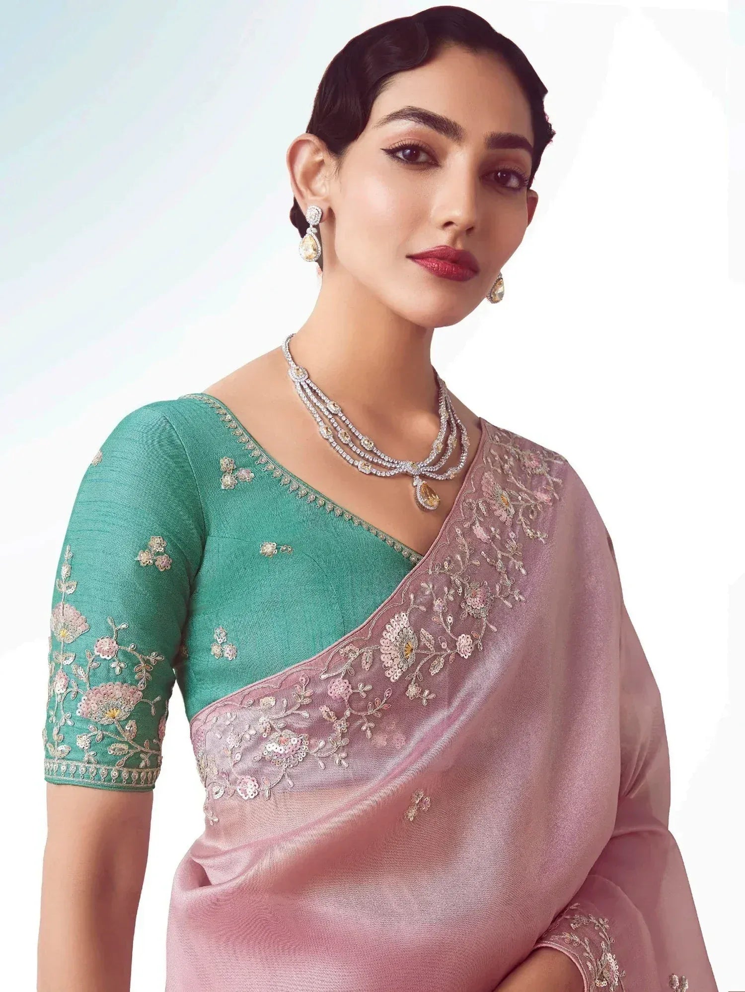 Elegant pink and green embroidered saree with floral detailing, perfect for Indian ethnic occasions.