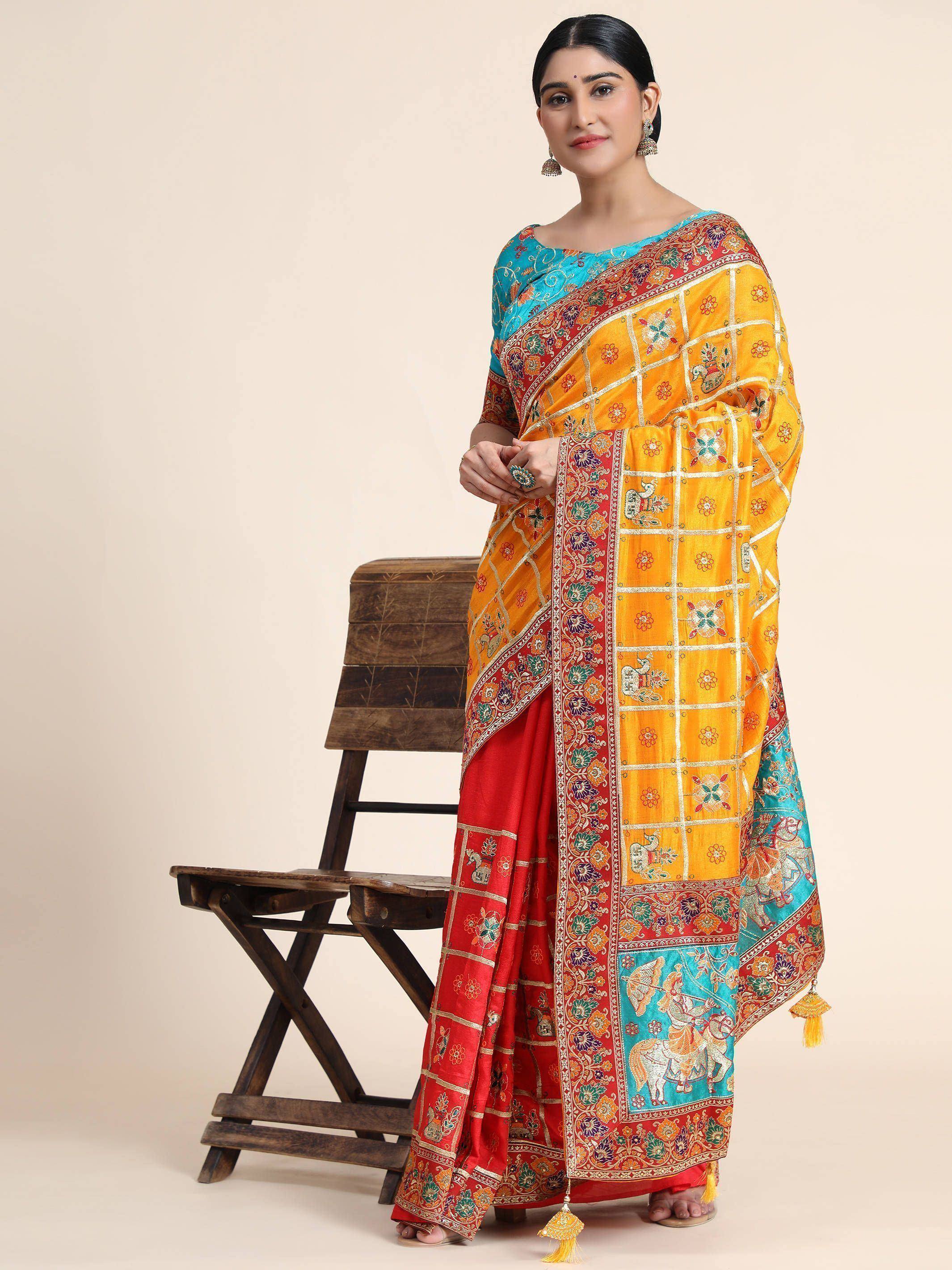 Vibrant yellow and red embroidered saree with floral and elephant motifs, paired with blue blouse, perfect for Indian ethnic wear.