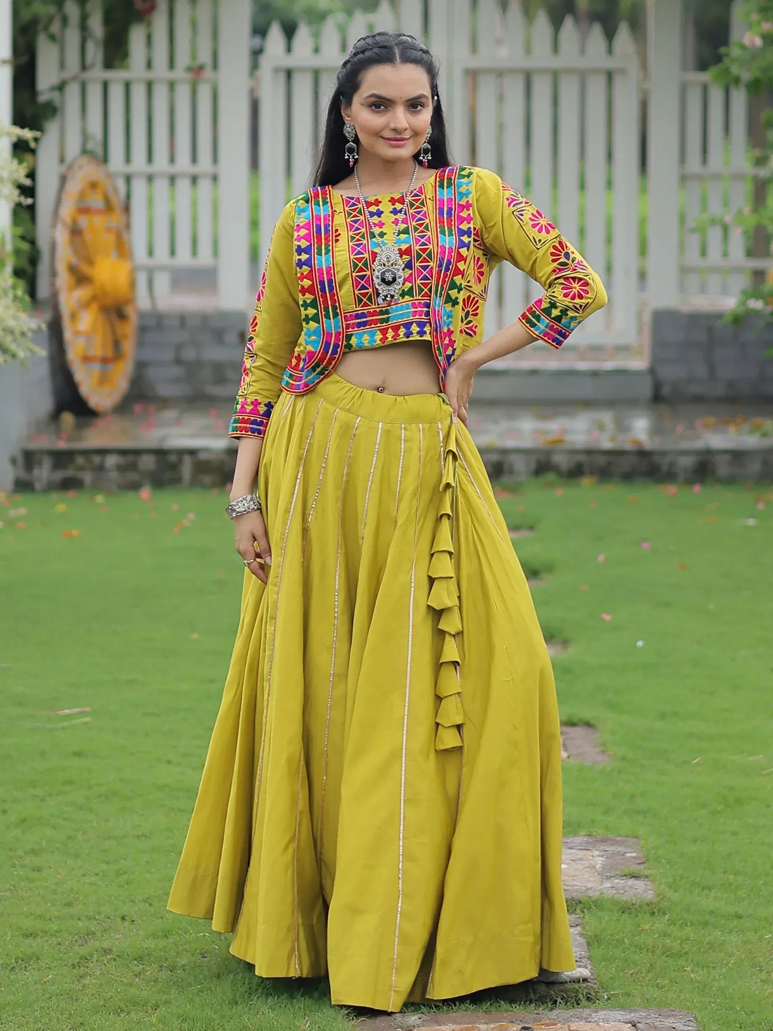 Yellow embroidered lehenga choli with colorful mirror work, perfect for Indian ethnic wear occasions