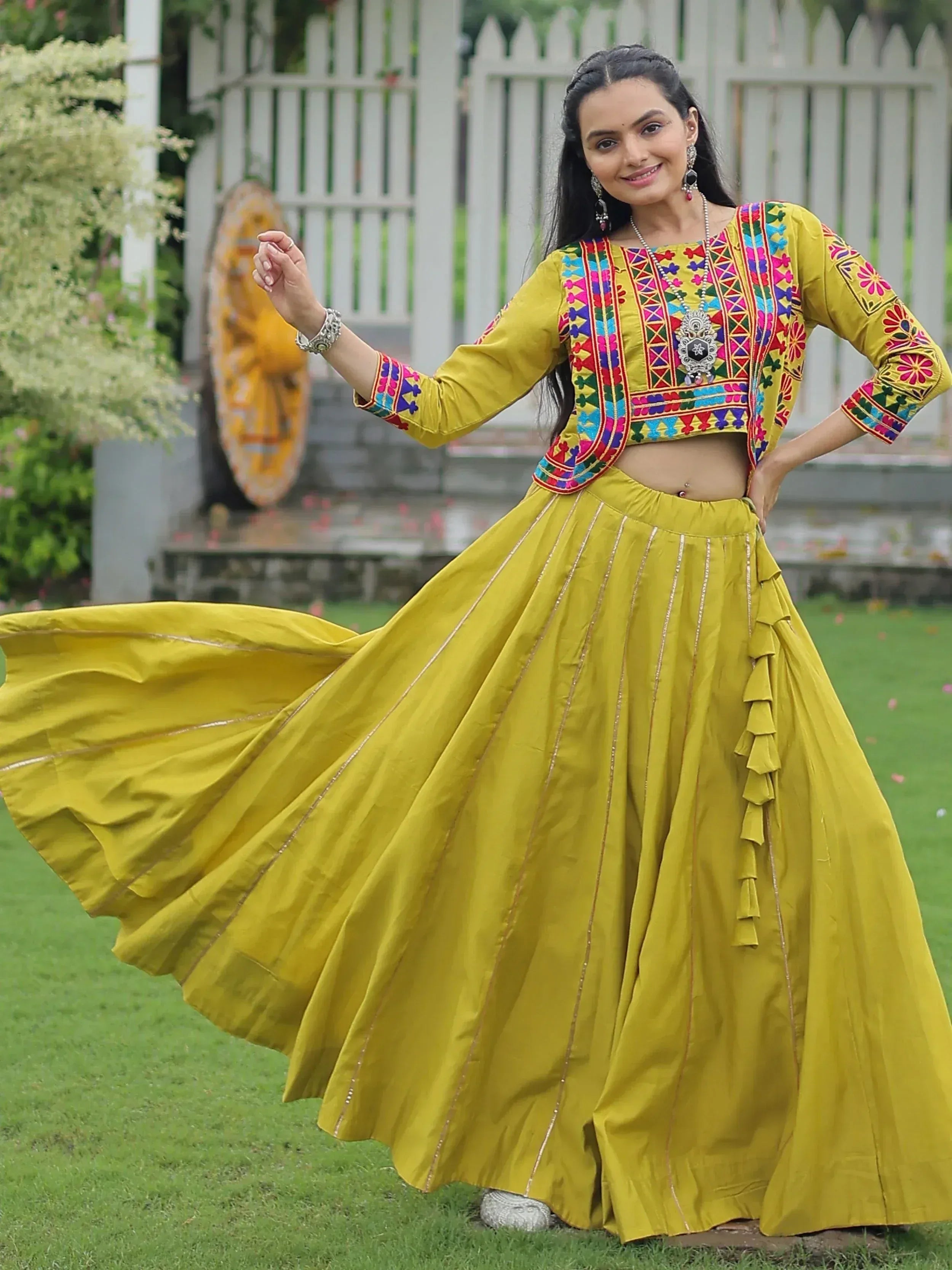 Yellow embroidered ethnic lehenga choli with floral patterns, perfect for Indian festive wear