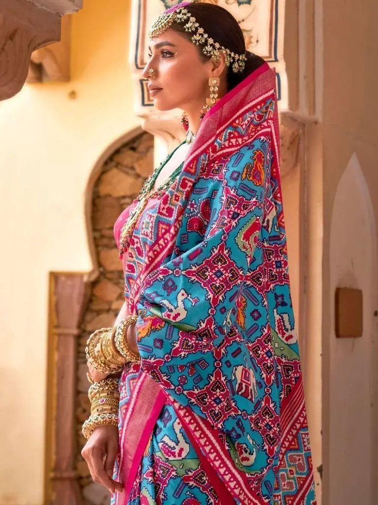 Stunning Sky Blue and Regal Rani Patola Silk Reception Saree and Blouse
