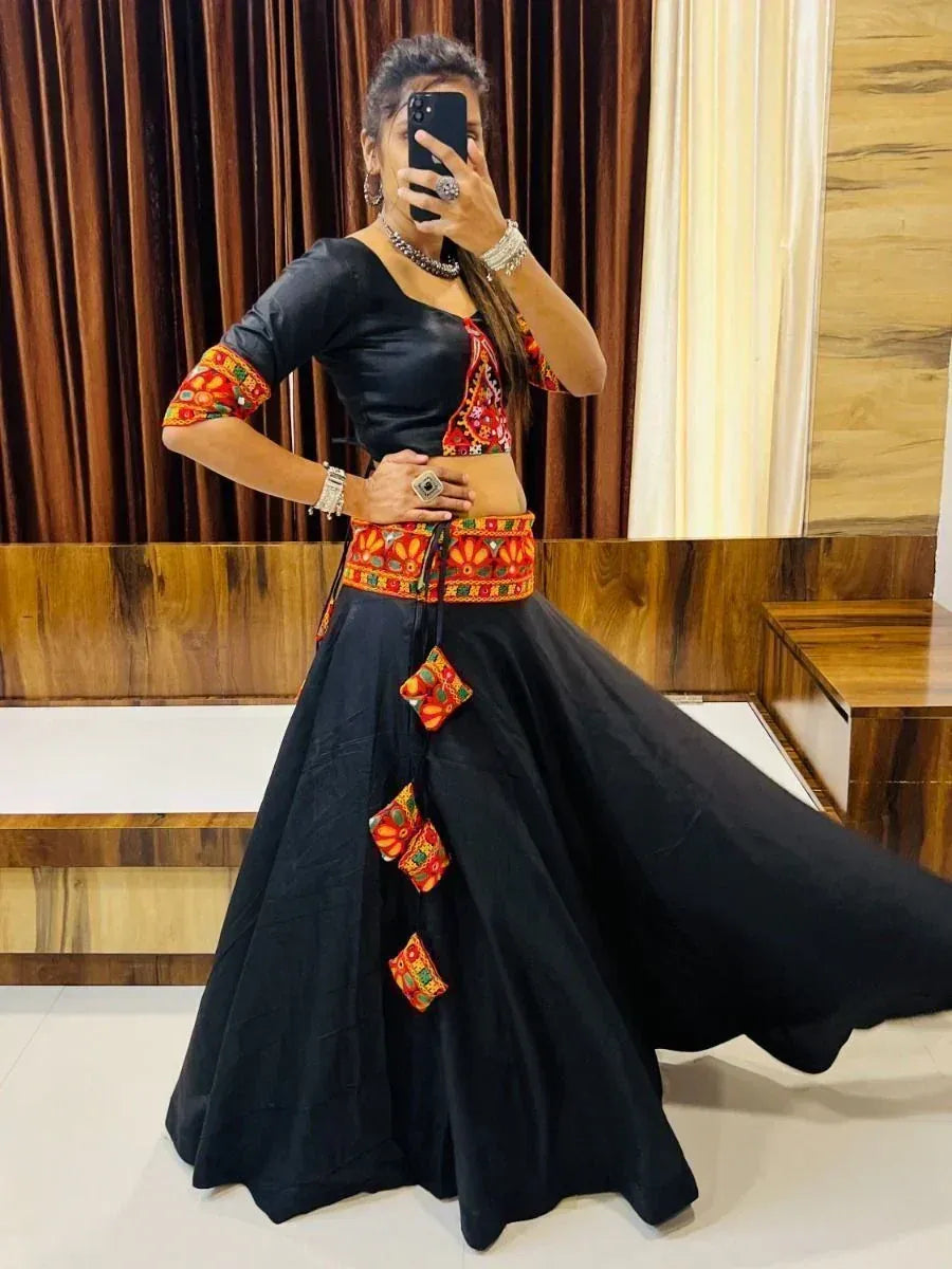 Black ethnic lehenga choli with vibrant red and orange embroidery, perfect for festive occasions