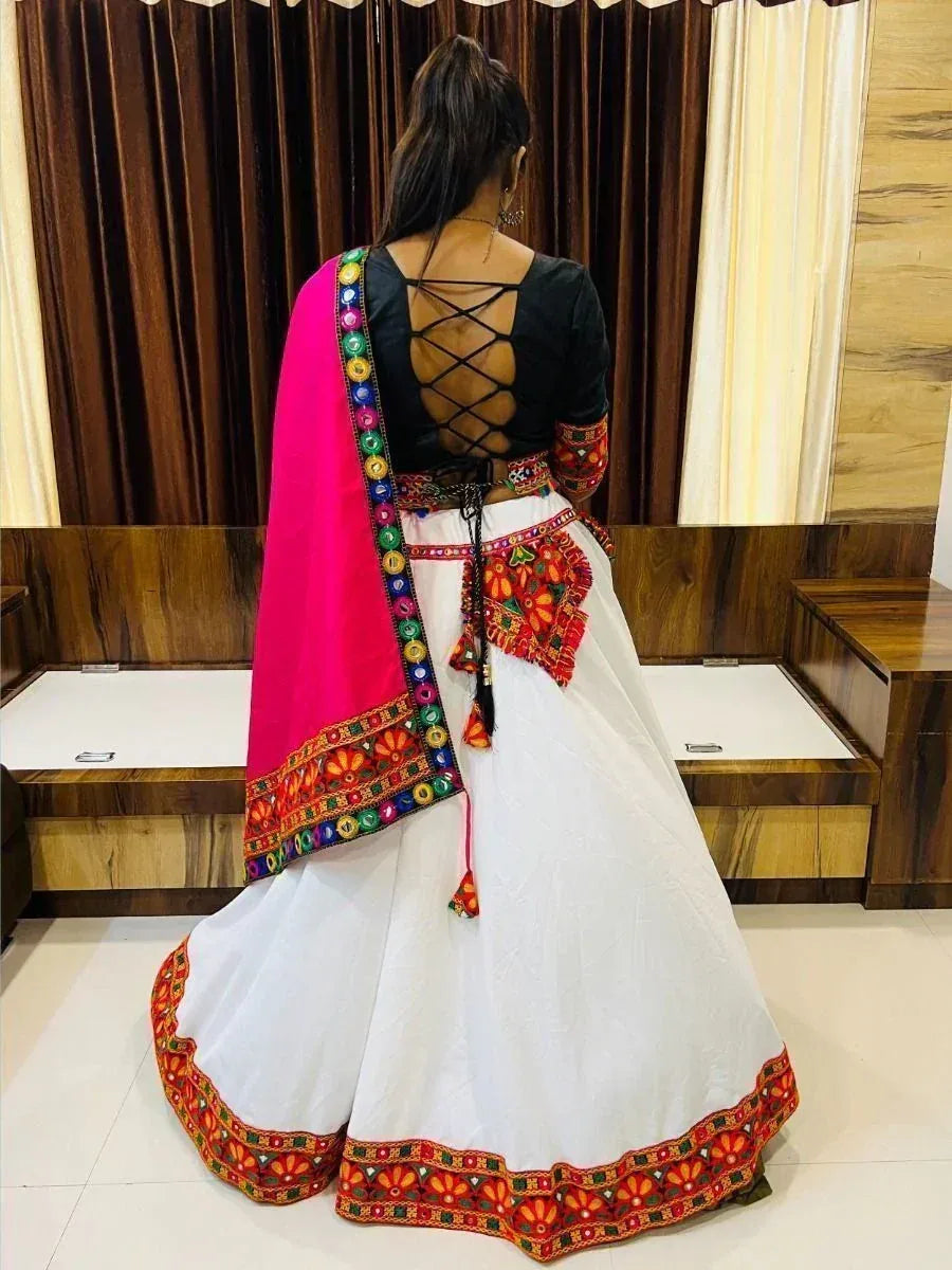 White embroidered lehenga choli with black crisscross back blouse and pink dupatta, ethnic Indian wear