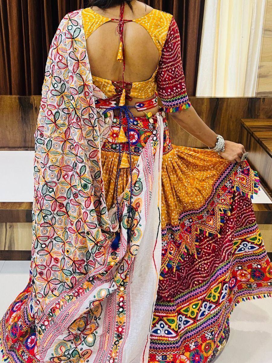 Vibrant Indian ethnic lehenga choli with colorful mirror work, backless blouse, and embroidered dupatta