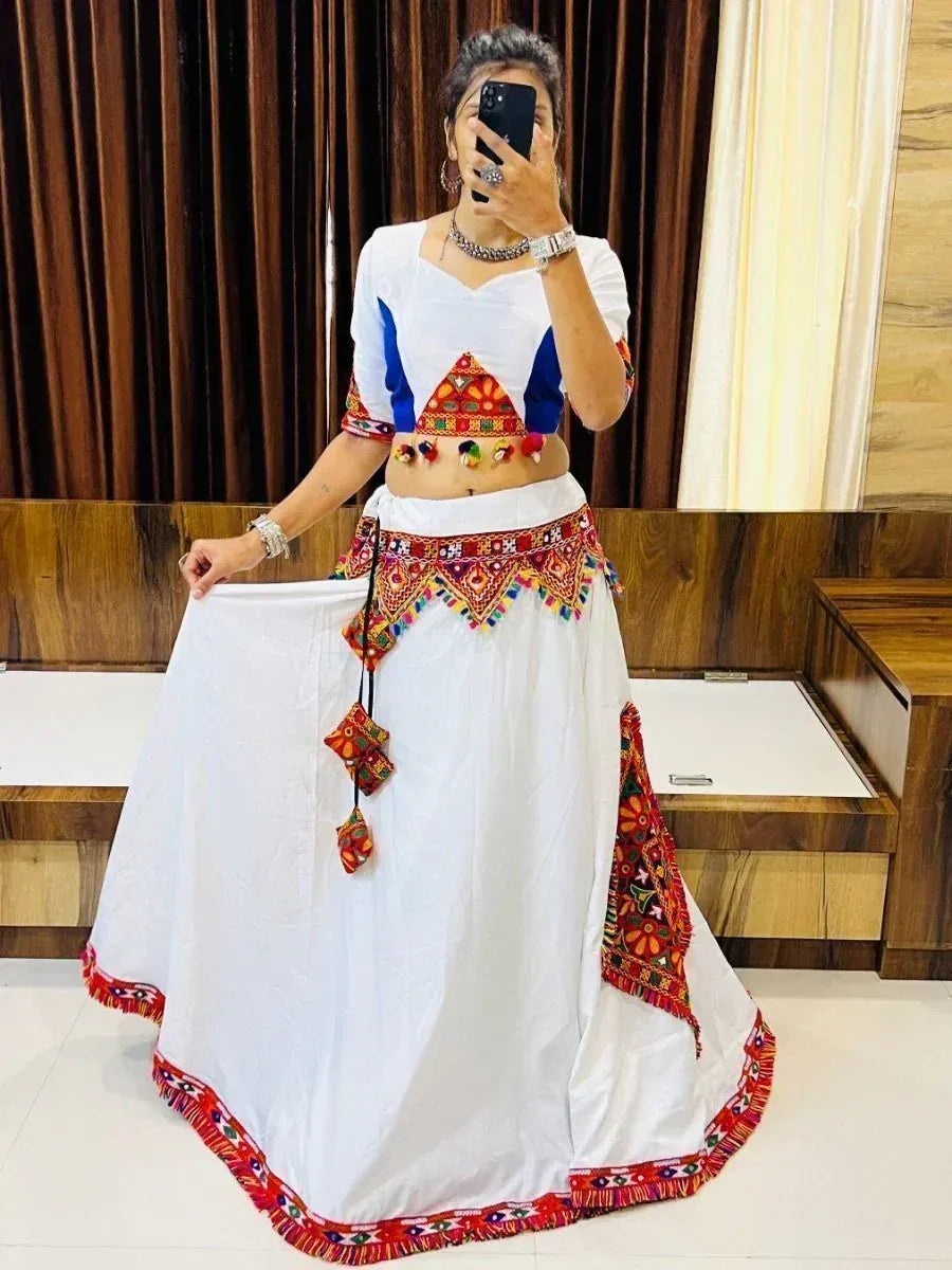White ethnic skirt with colorful embroidery and mirror work, paired with blue and white crop top