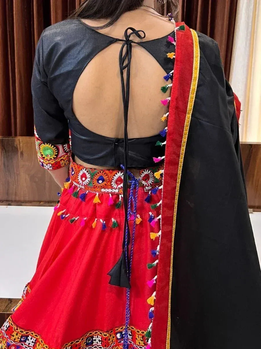 Red embroidered lehenga with black backless blouse and colorful tassels, ethnic Indian wear