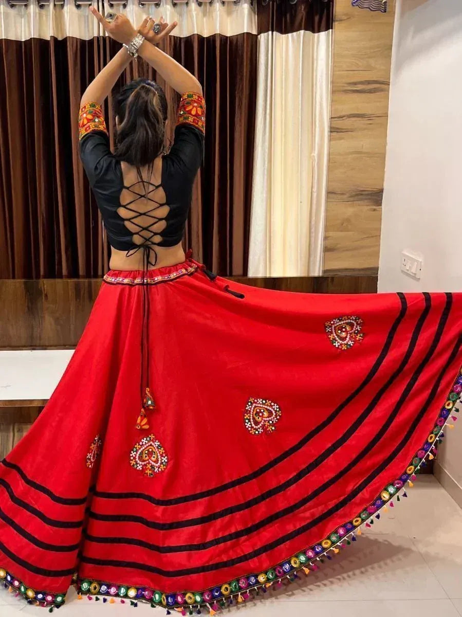 Red embroidered ethnic skirt with black top, perfect for Indian dance or festive occasions