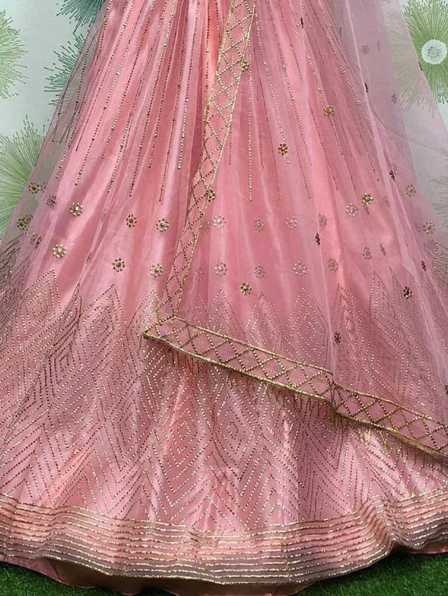 Pink designer lehenga with gold embroidery and geometric patterns, ideal for Indian ethnic wear
