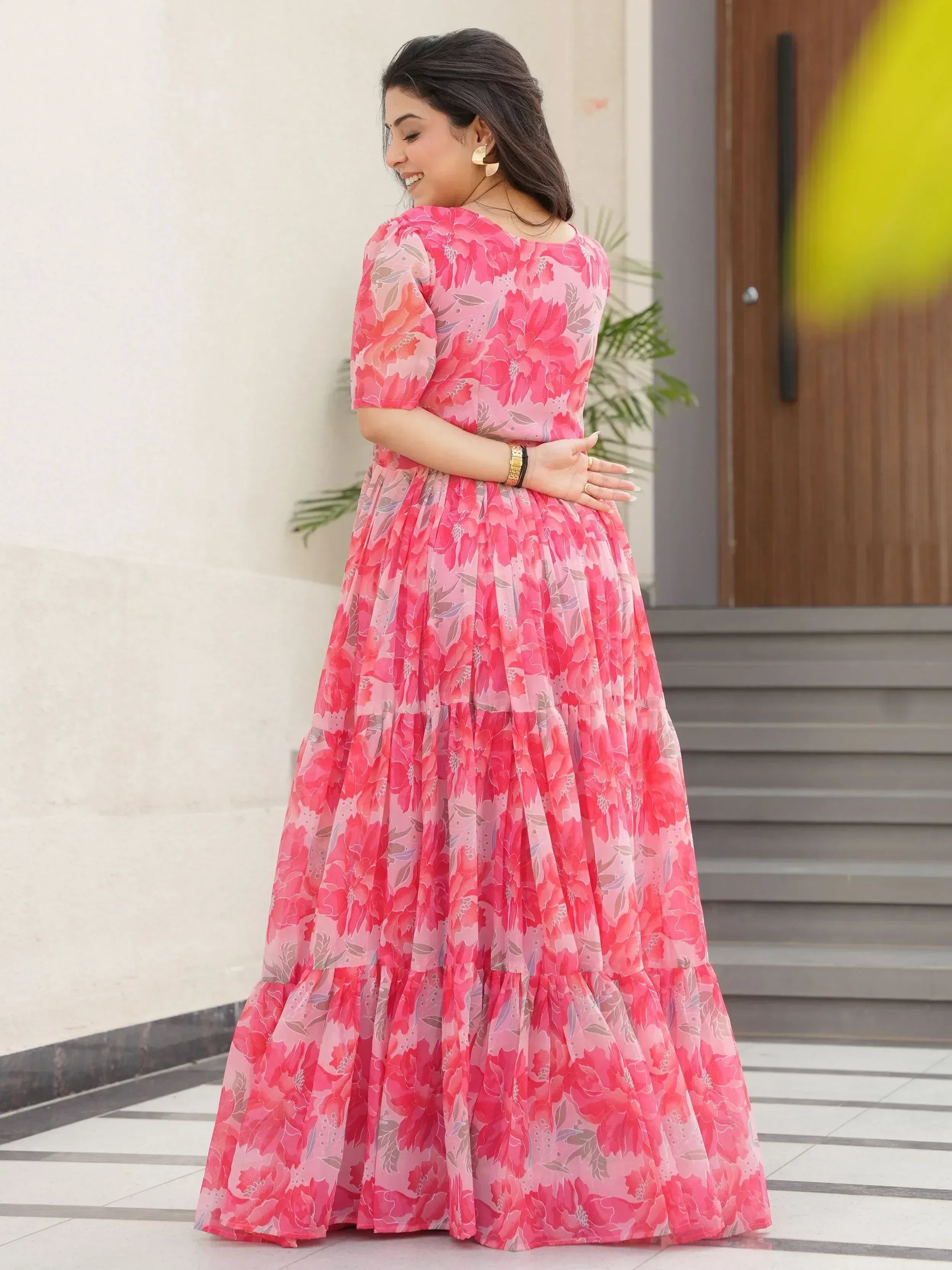 Pink floral ethnic gown with tiered skirt, perfect for Indian occasions and festive wear.