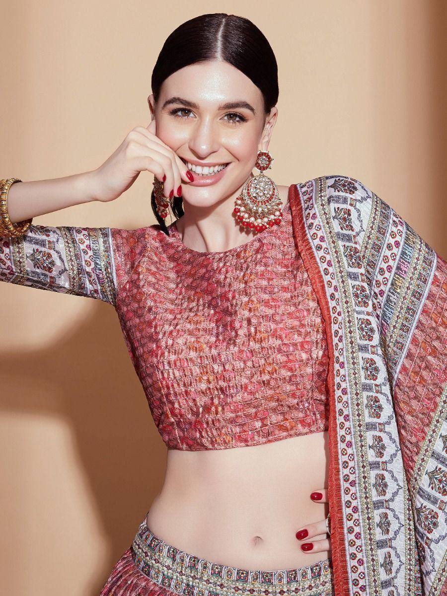 Woman in red embroidered lehenga choli with matching dupatta and jhumka earrings, Indian ethnic wear