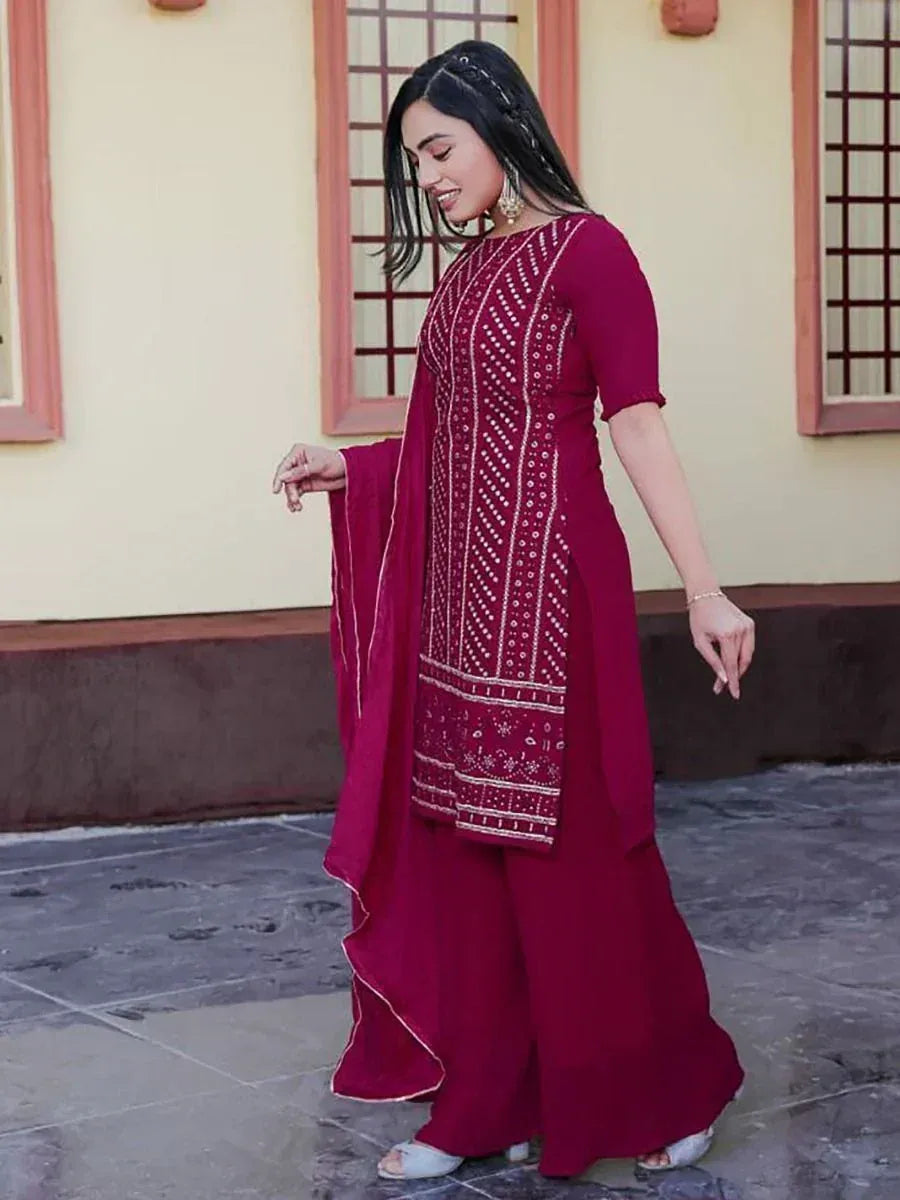 Woman in maroon embroidered salwar kameez with dupatta, traditional Indian ethnic wear