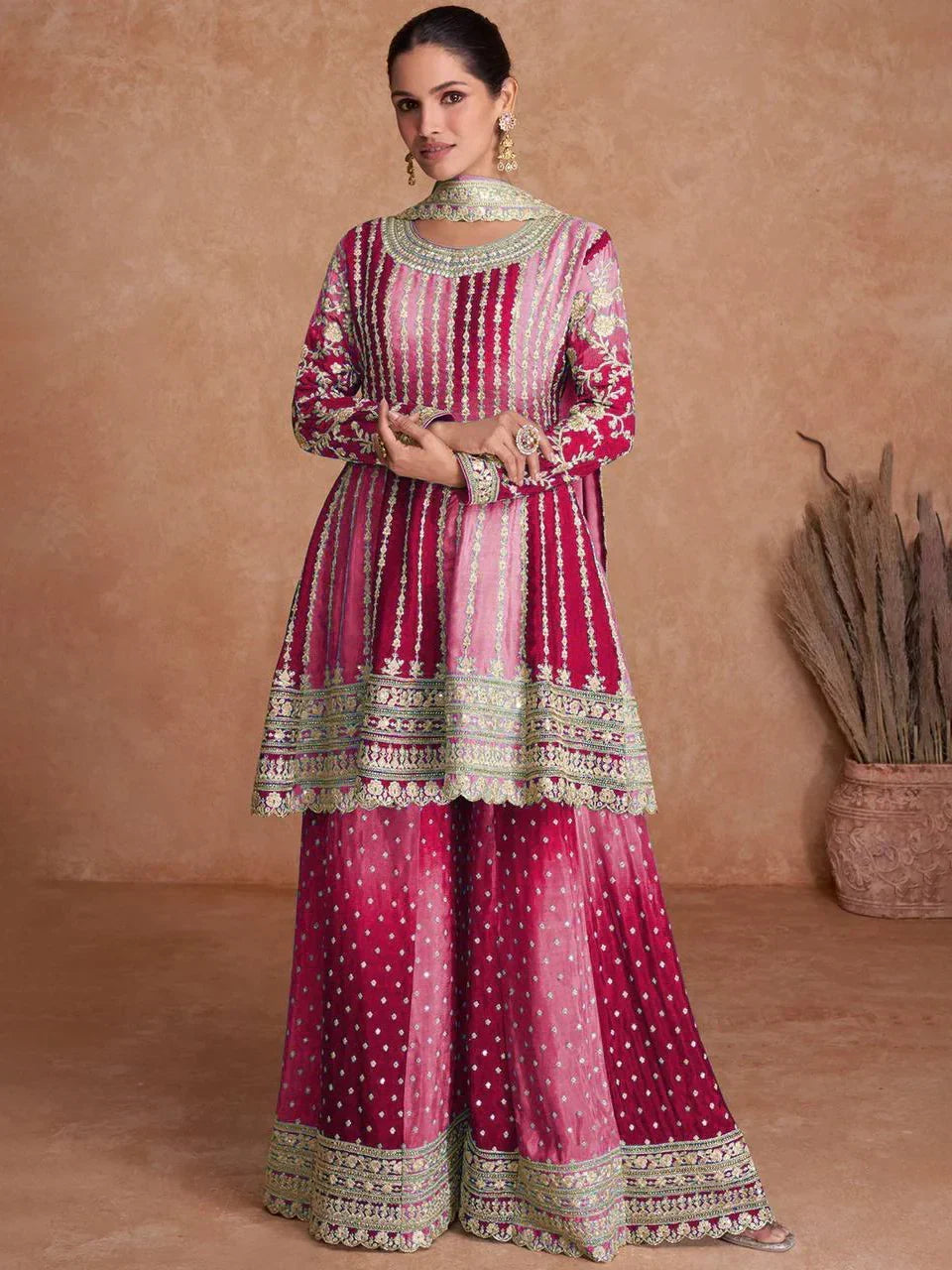 Woman in pink embroidered Indian ethnic suit with flared palazzo pants and dupatta