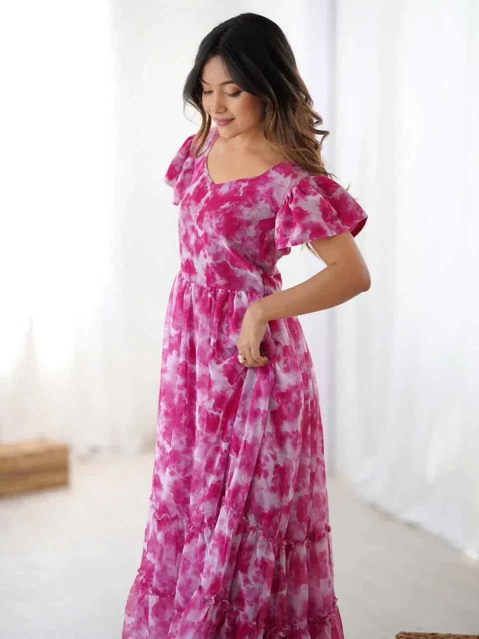 Pink tie-dye ethnic gown with ruffled sleeves and tiered skirt, perfect for Indian occasions