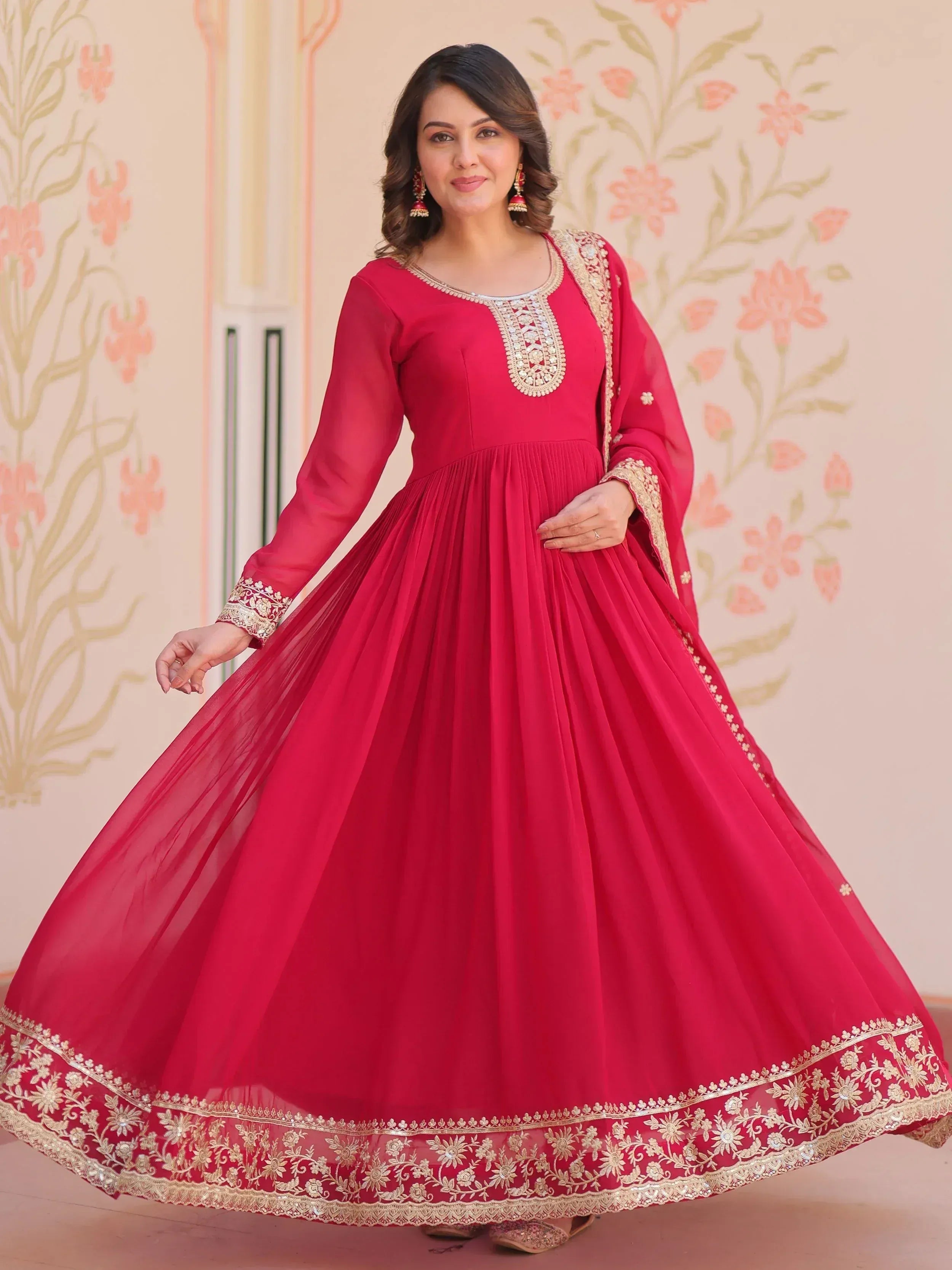 Red ethnic gown with gold embroidery, perfect for Indian celebrations and festive occasions.