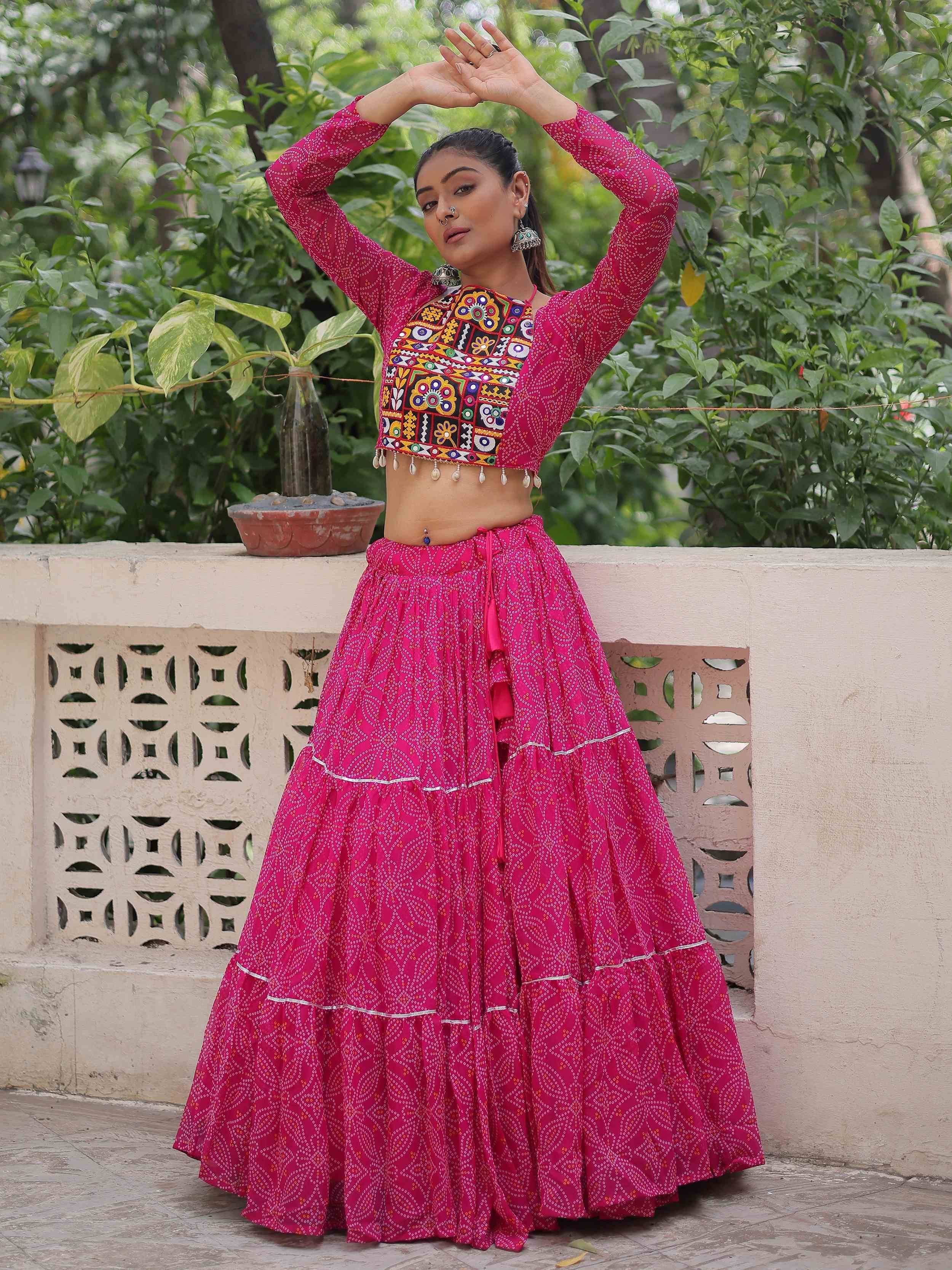 Vibrant pink ethnic lehenga choli with mirror work blouse, perfect for Indian festivals and weddings