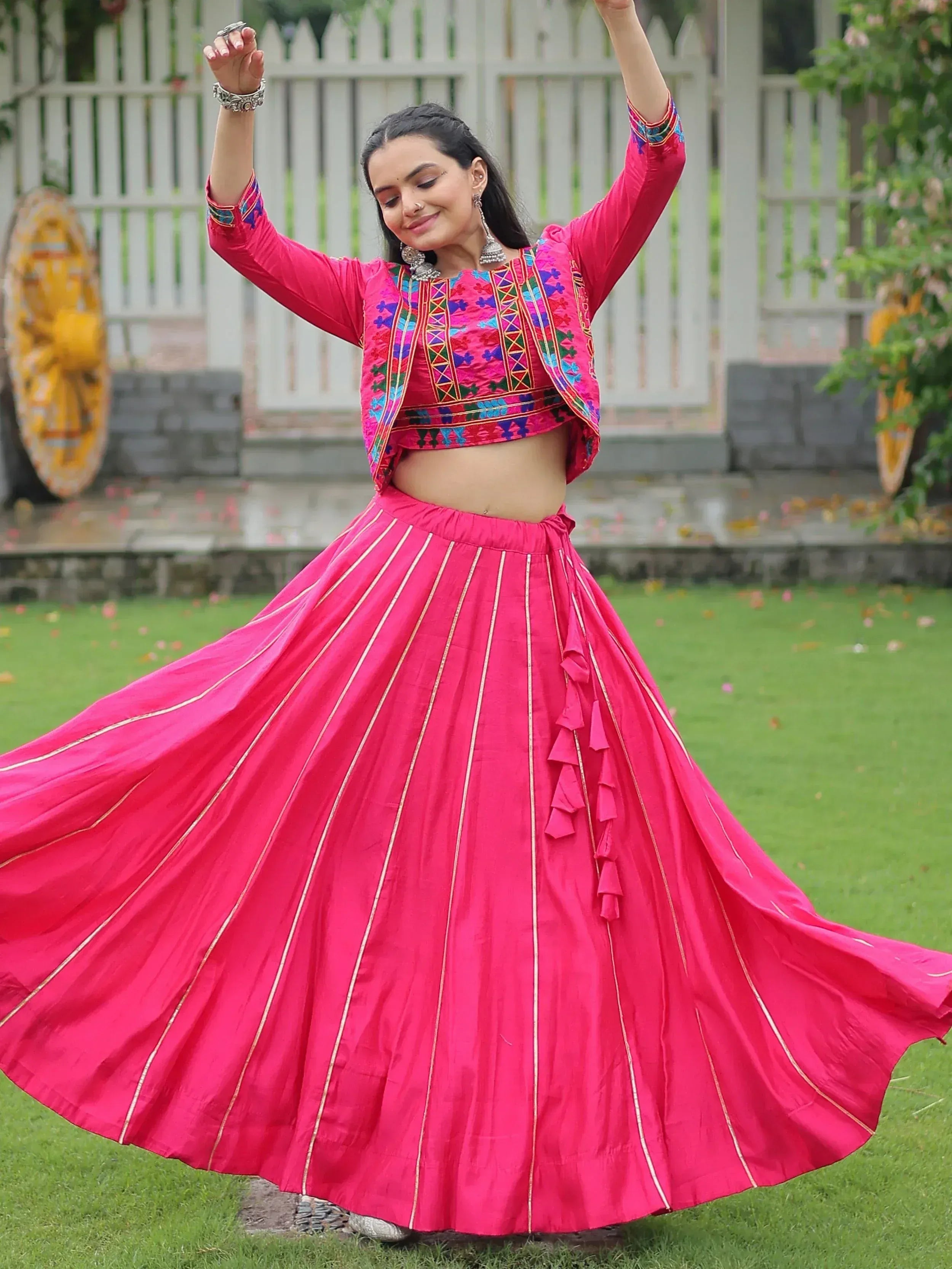 Vibrant pink embroidered lehenga choli with flared skirt, perfect for Indian ethnic wear and festive occasions.
