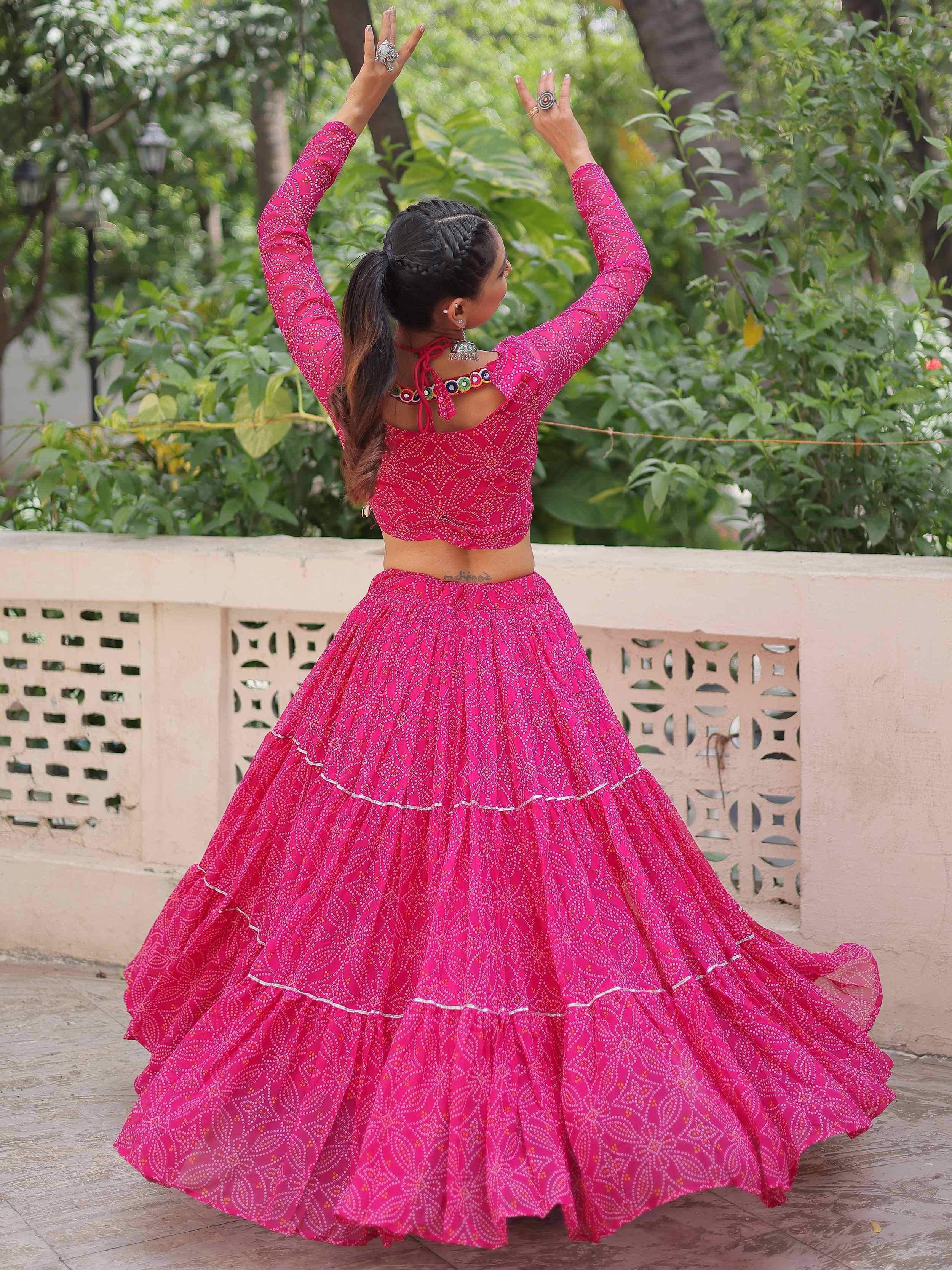 Vibrant pink ethnic lehenga choli with printed patterns, perfect for festive occasions and traditional celebrations.