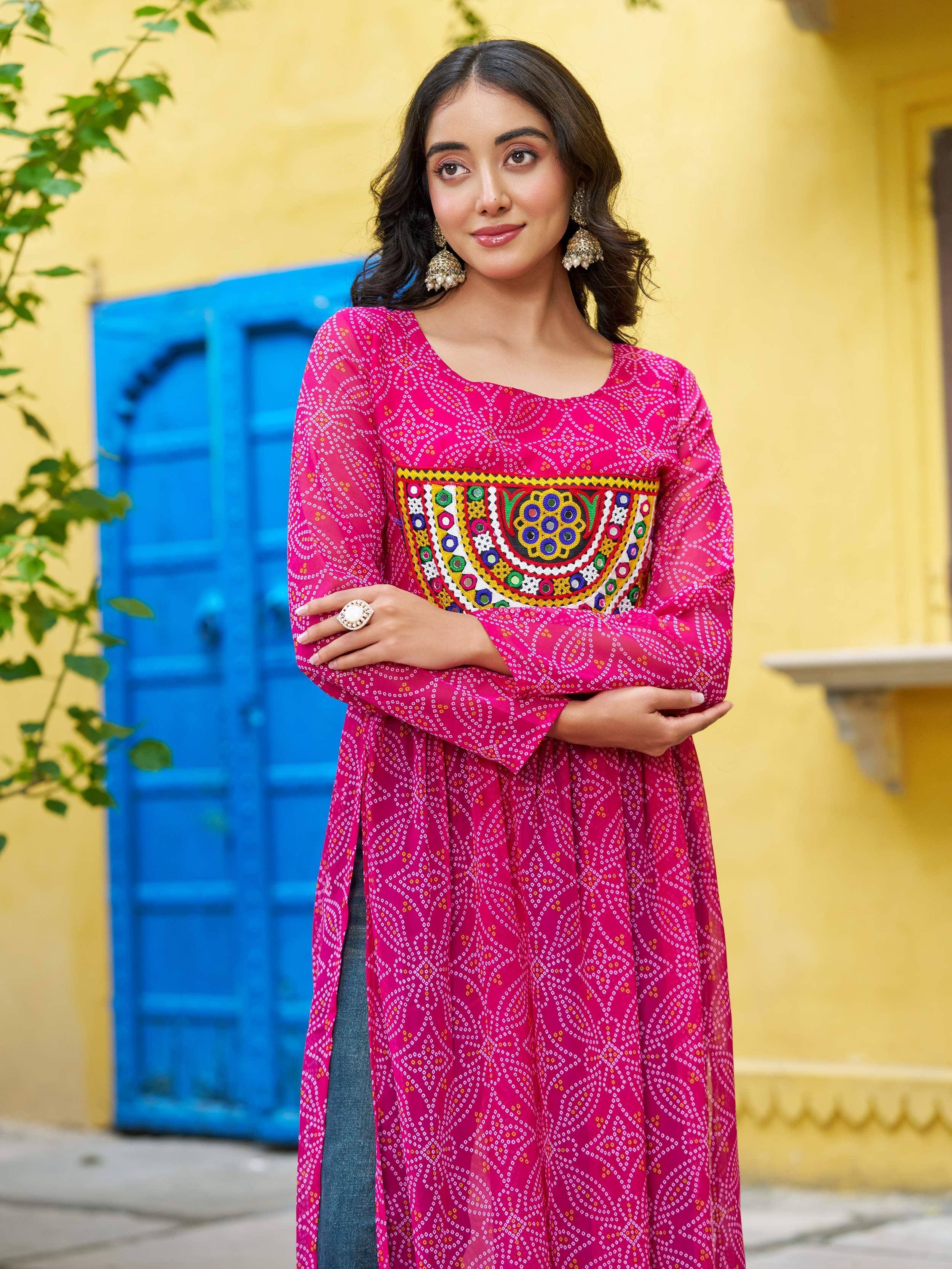 Pink ethnic kurta with mirror work and bandhani print, paired with jeans, for festive Indian wear